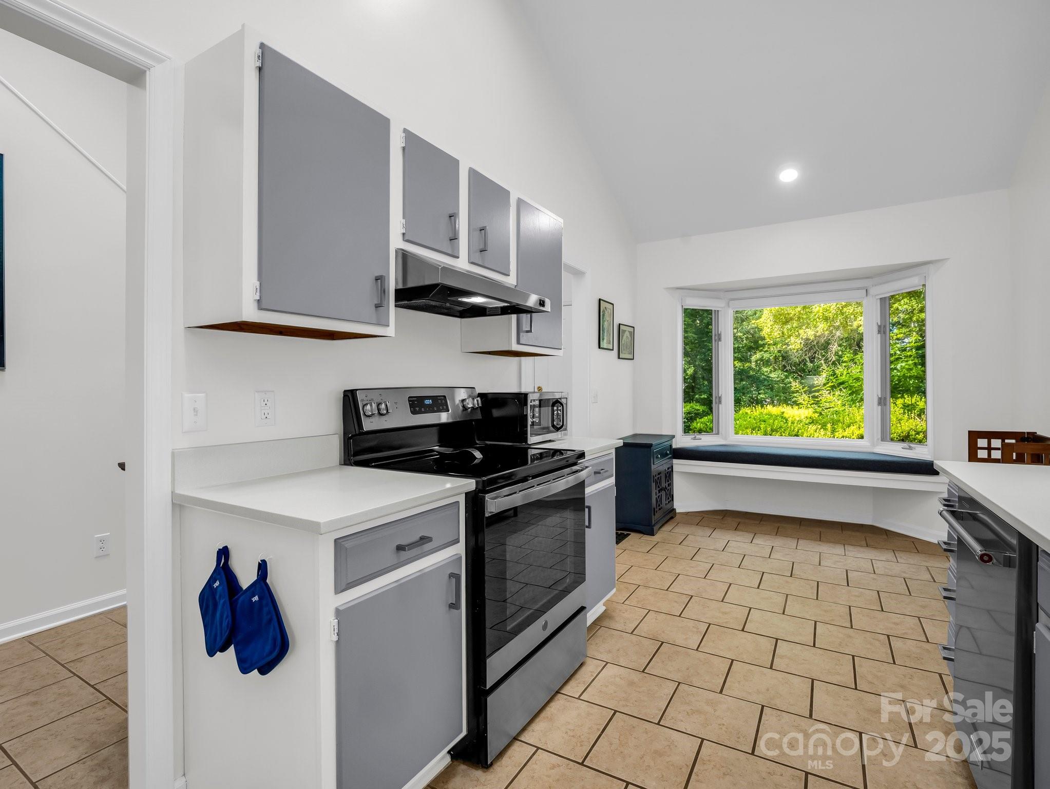 8 Hunting Country Trail Tryon, NC 28782 - Photo 11 of 37 a kitchen with stainless steel appliances a stove a sink and a window