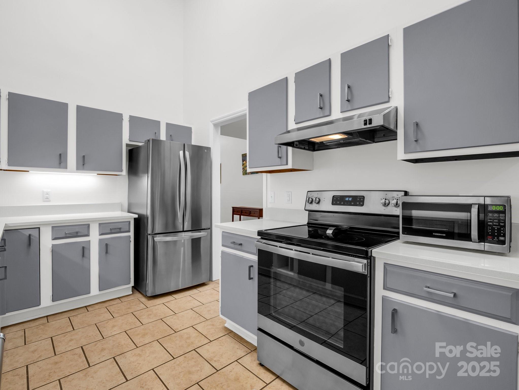 8 Hunting Country Trail Tryon, NC 28782 - Photo 13 of 37 a kitchen with stainless steel appliances granite countertop a stove a refrigerator and a cabinets