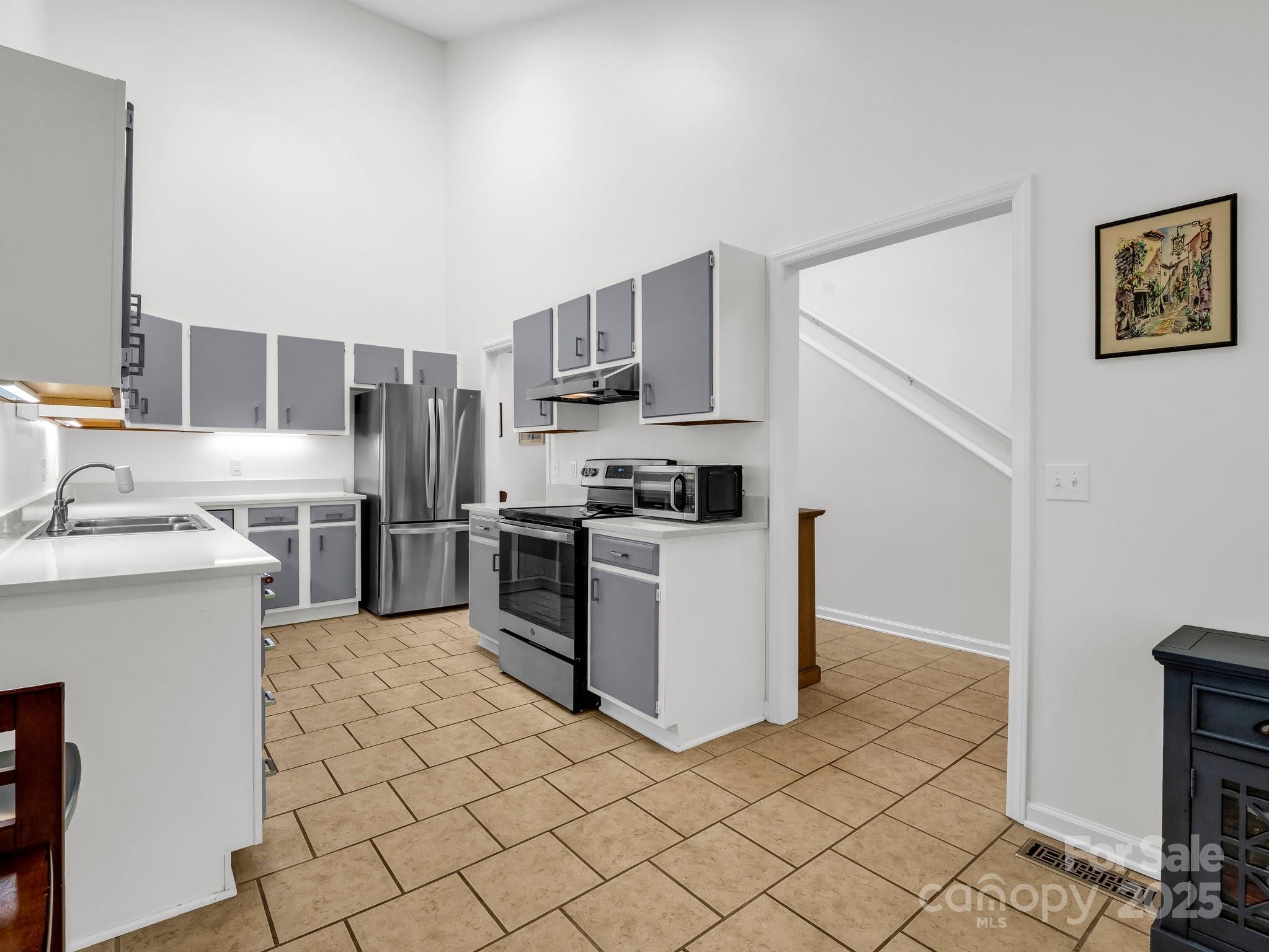 8 Hunting Country Trail Tryon, NC 28782 - Photo 15 of 37 a kitchen with stainless steel appliances granite countertop a refrigerator sink and stove