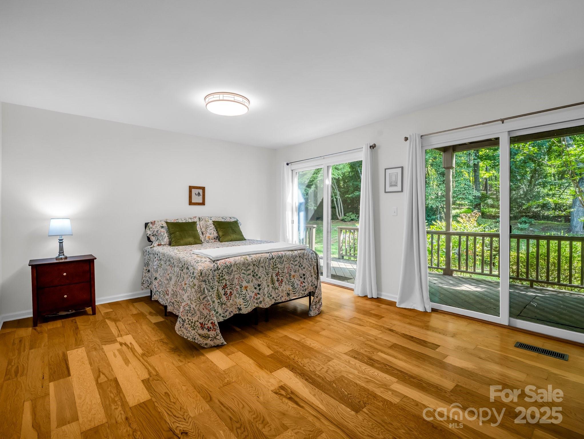 8 Hunting Country Trail Tryon, NC 28782 - Photo 20 of 37 a bedroom with a bed and wooden floor