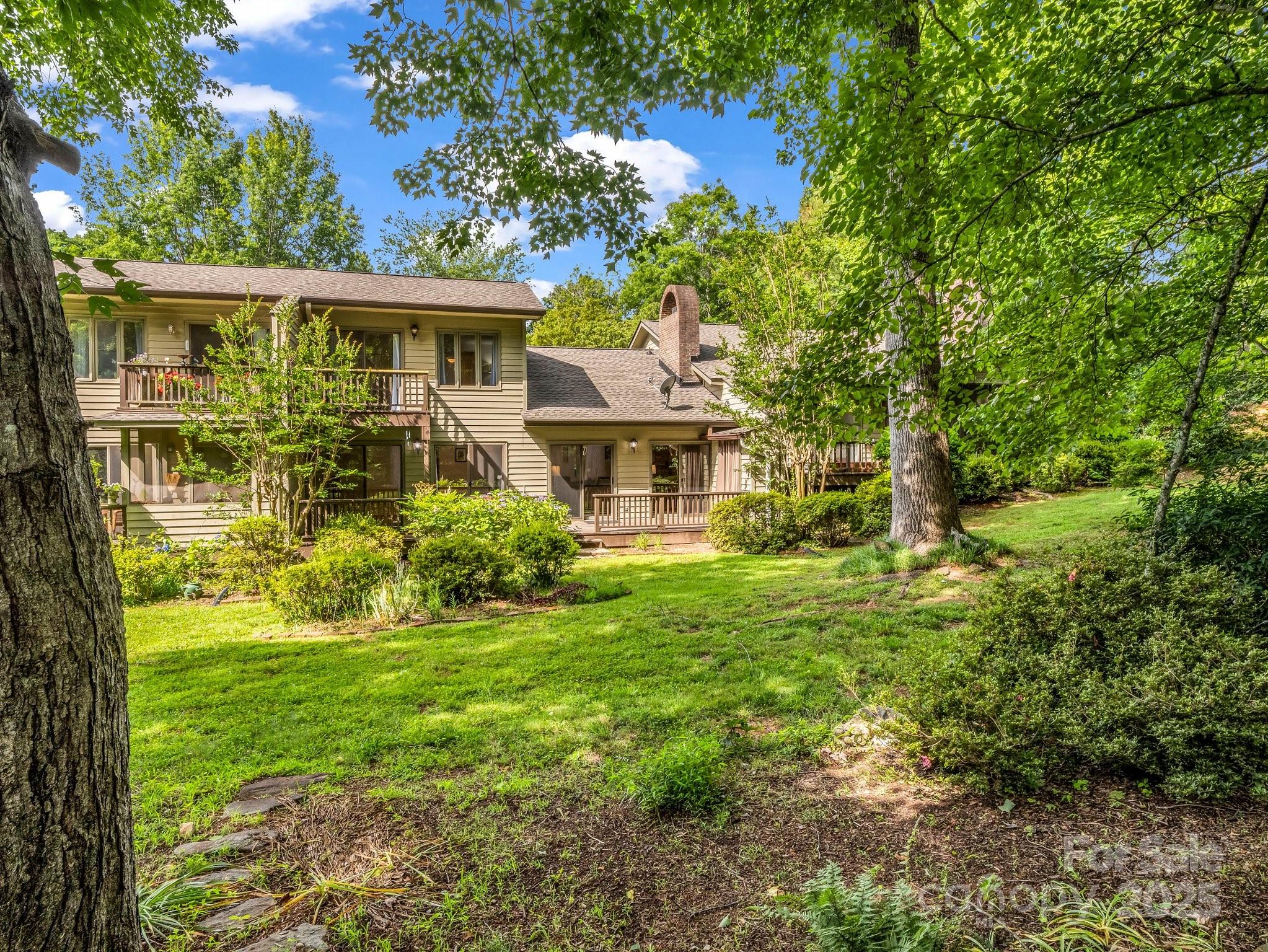 8 Hunting Country Trail Tryon, NC 28782 - Photo 2 of 37 a front view of a house with a yard