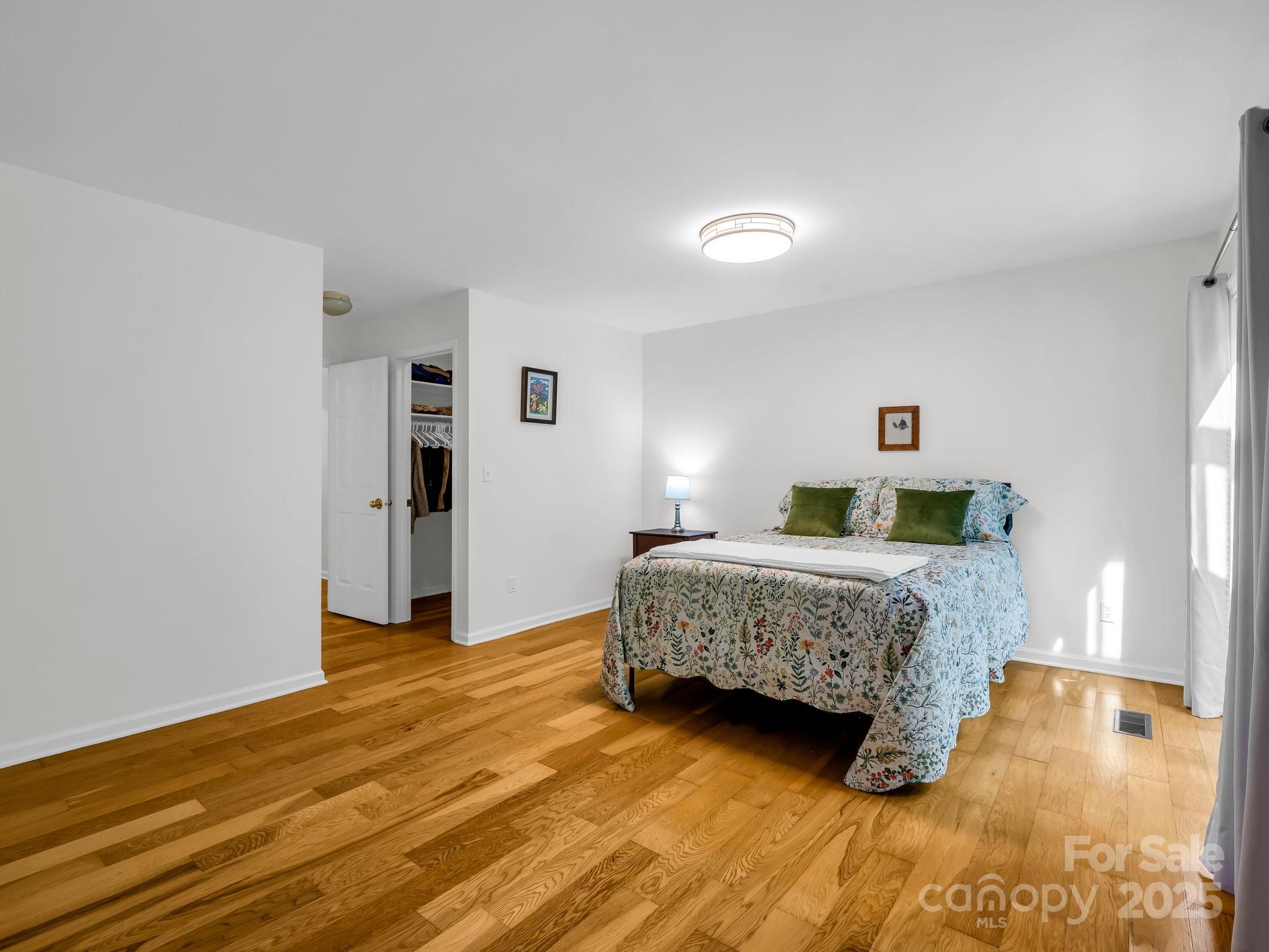 8 Hunting Country Trail Tryon, NC 28782 - Photo 21 of 37 a bedroom with a bed and wooden floor