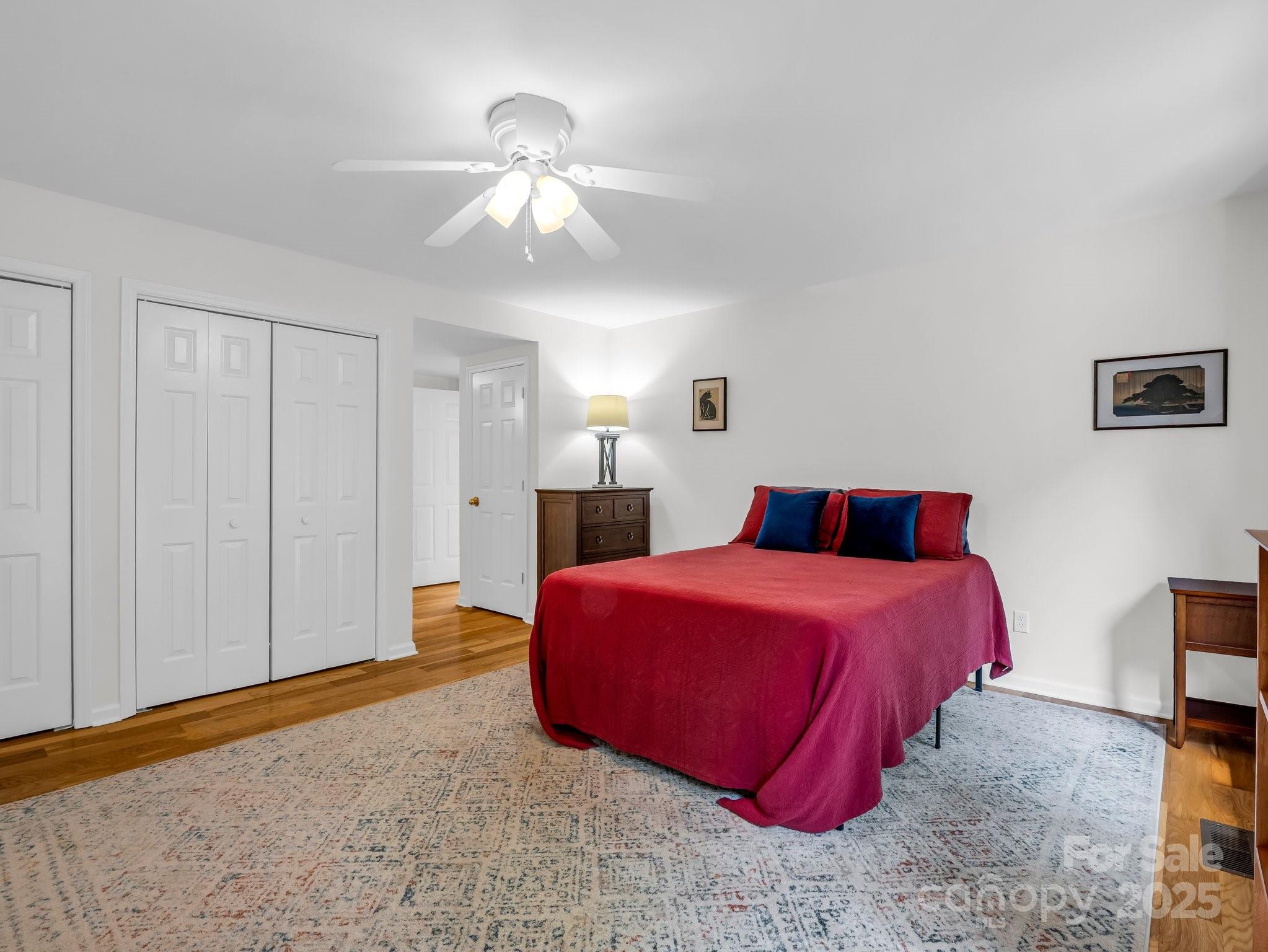 8 Hunting Country Trail Tryon, NC 28782 - Photo 27 of 37 a bedroom with a bed and a chandelier