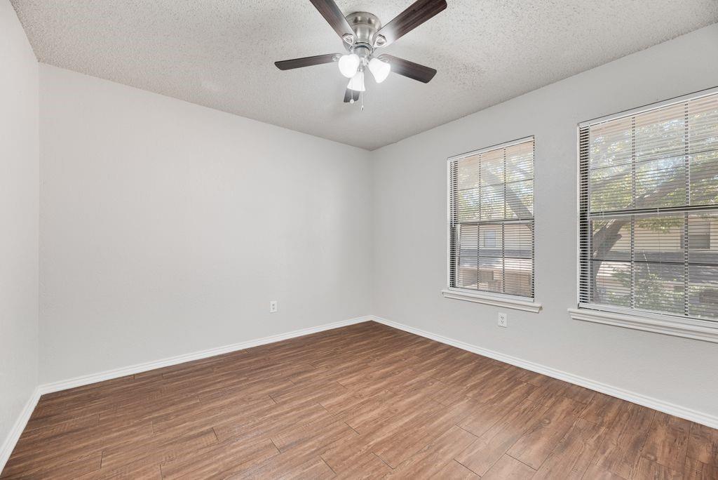 648 South Rogers Road, Unit 648 Irving, TX 75060 - Photo 12 of 20 wooden floor in an empty room with a window
