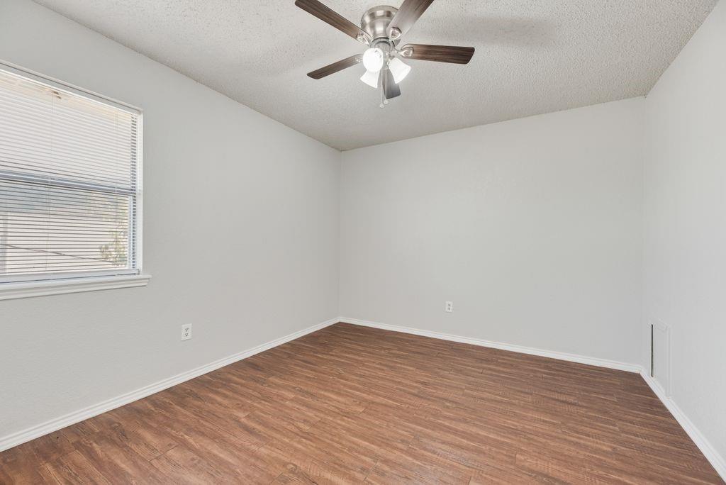 648 South Rogers Road, Unit 648 Irving, TX 75060 - Photo 13 of 20 a view of an empty room with wooden floor and a window