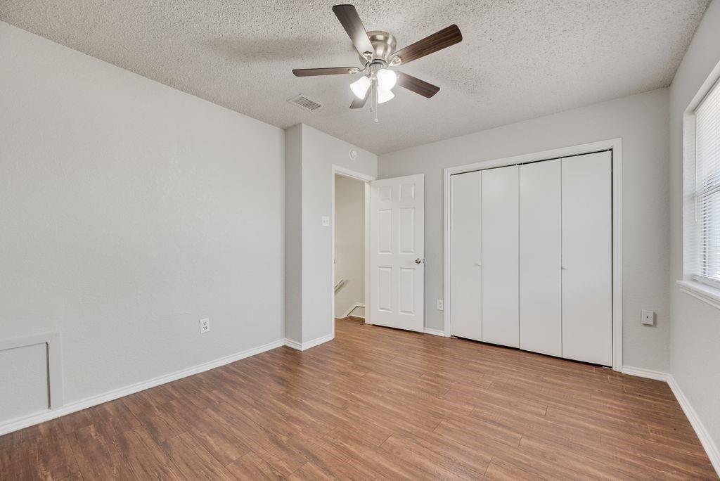 648 South Rogers Road, Unit 648 Irving, TX 75060 - Photo 14 of 20 a view of an empty room with wooden floor