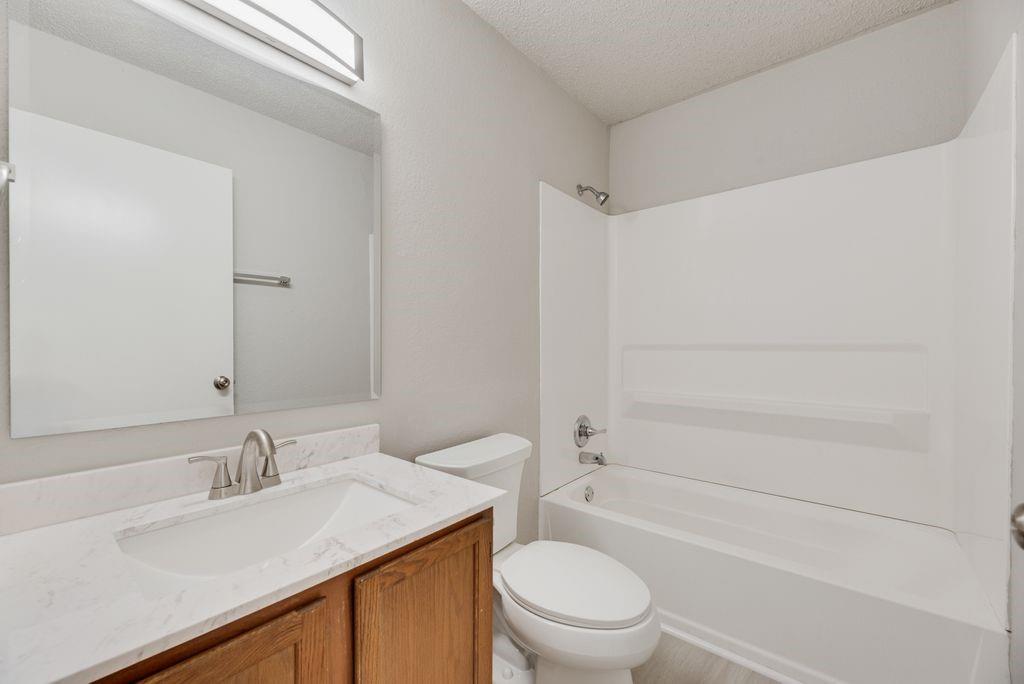 648 South Rogers Road, Unit 648 Irving, TX 75060 - Photo 15 of 20 a bathroom with a sink toilet vanity and shower