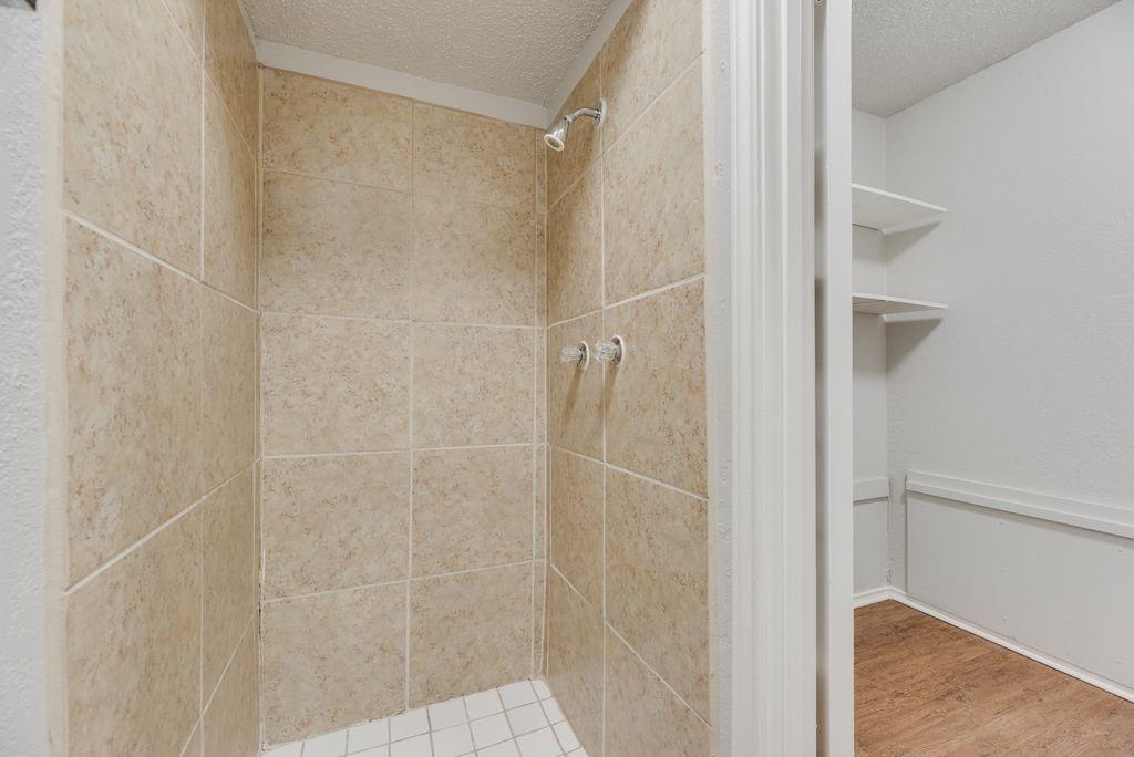 648 South Rogers Road, Unit 648 Irving, TX 75060 - Photo 17 of 20 a bathroom with a glass shower door