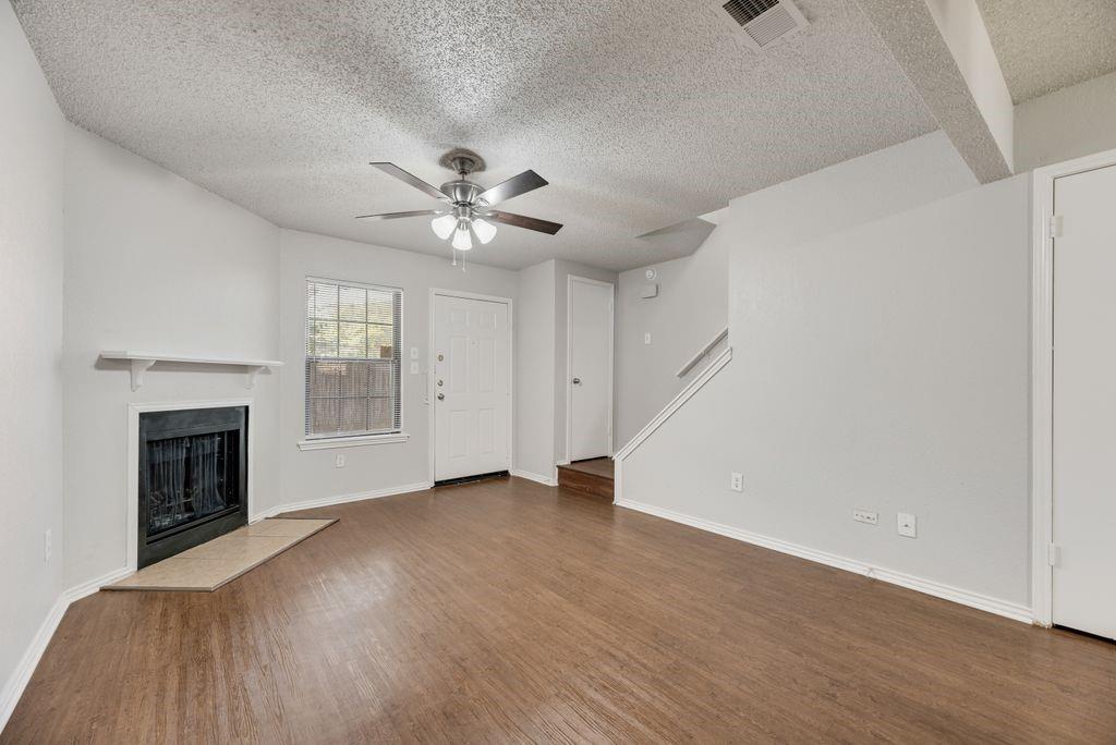 648 South Rogers Road, Unit 648 Irving, TX 75060 - Photo 4 of 20 a view of an empty room with a fireplace and a window