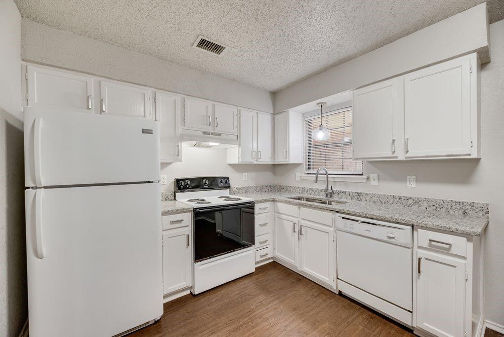 648 South Rogers Road, Unit 648 Irving, TX 75060 - Photo 8 of 20 a kitchen with stainless steel appliances granite countertop refrigerator sink and cabinets