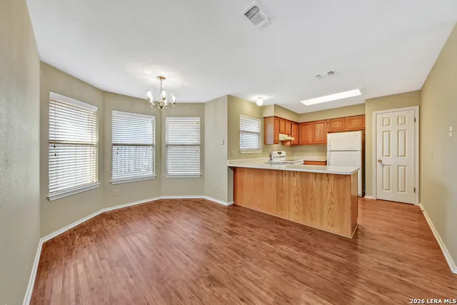 a view of kitchen with granite countertop cabinets and wooden floor