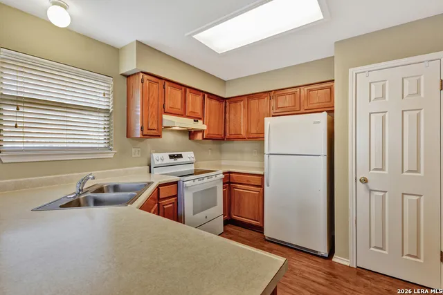 a kitchen with stainless steel appliances granite countertop a refrigerator sink and cabinets