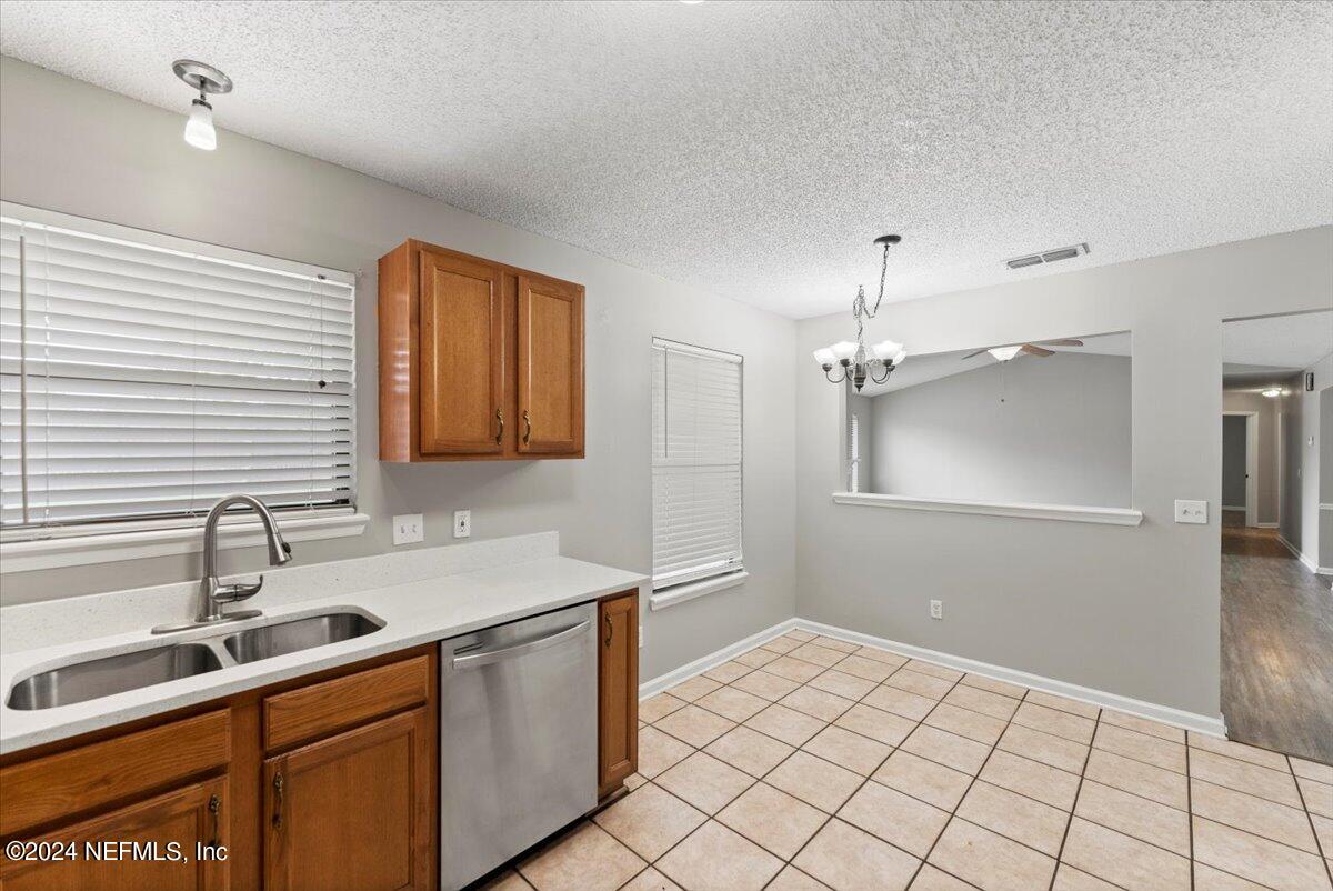 12342 Raleigh Ridge Drive Jacksonville, FL 32225 - Photo 6 of 28 a kitchen with a sink cabinets and window