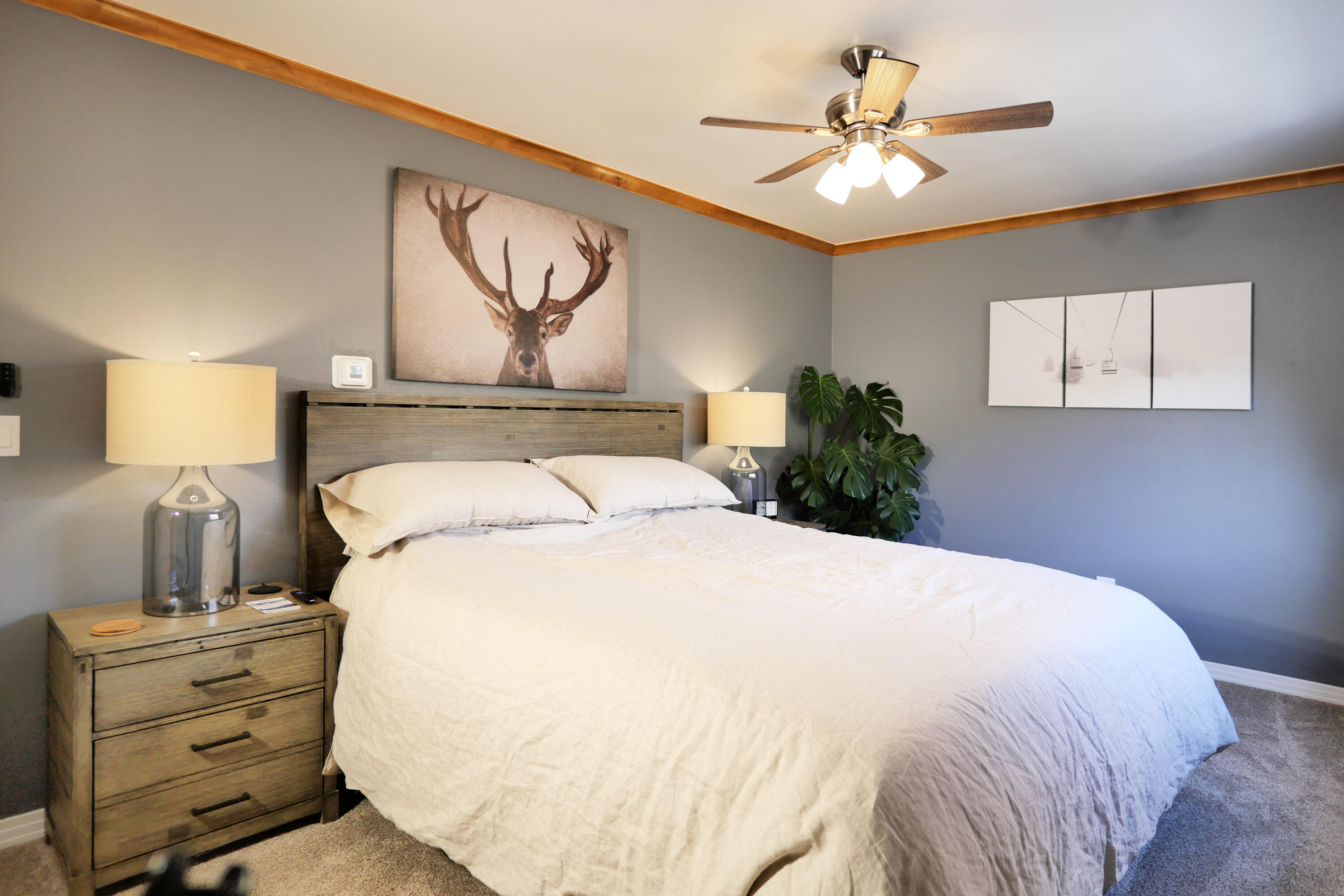 302 Adams Ranch Road, Unit 6 Mountain Village, CO 81435 - Photo 19 of 45 a bedroom with a bed and a chandelier