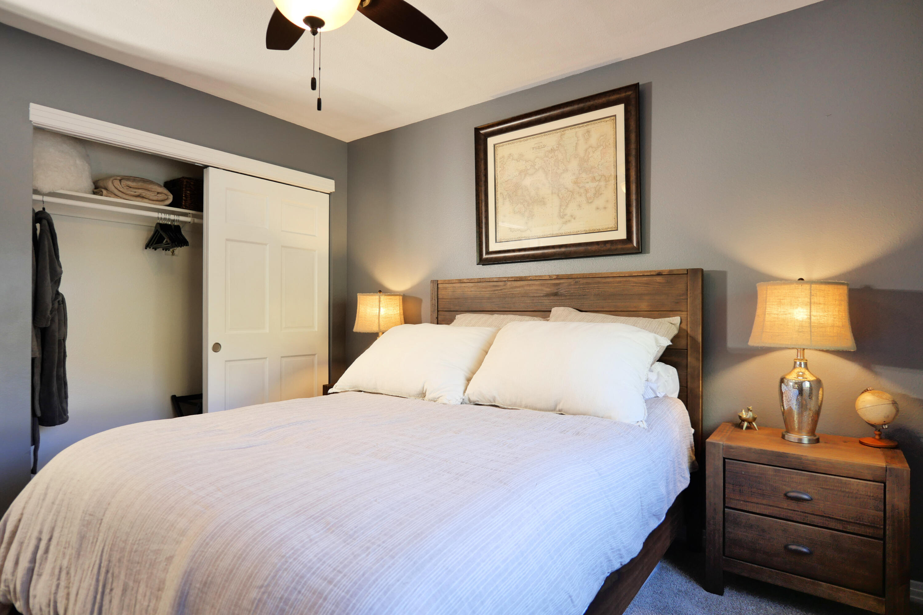 302 Adams Ranch Road, Unit 6 Mountain Village, CO 81435 - Photo 27 of 45 a bedroom with a bed and a chandelier