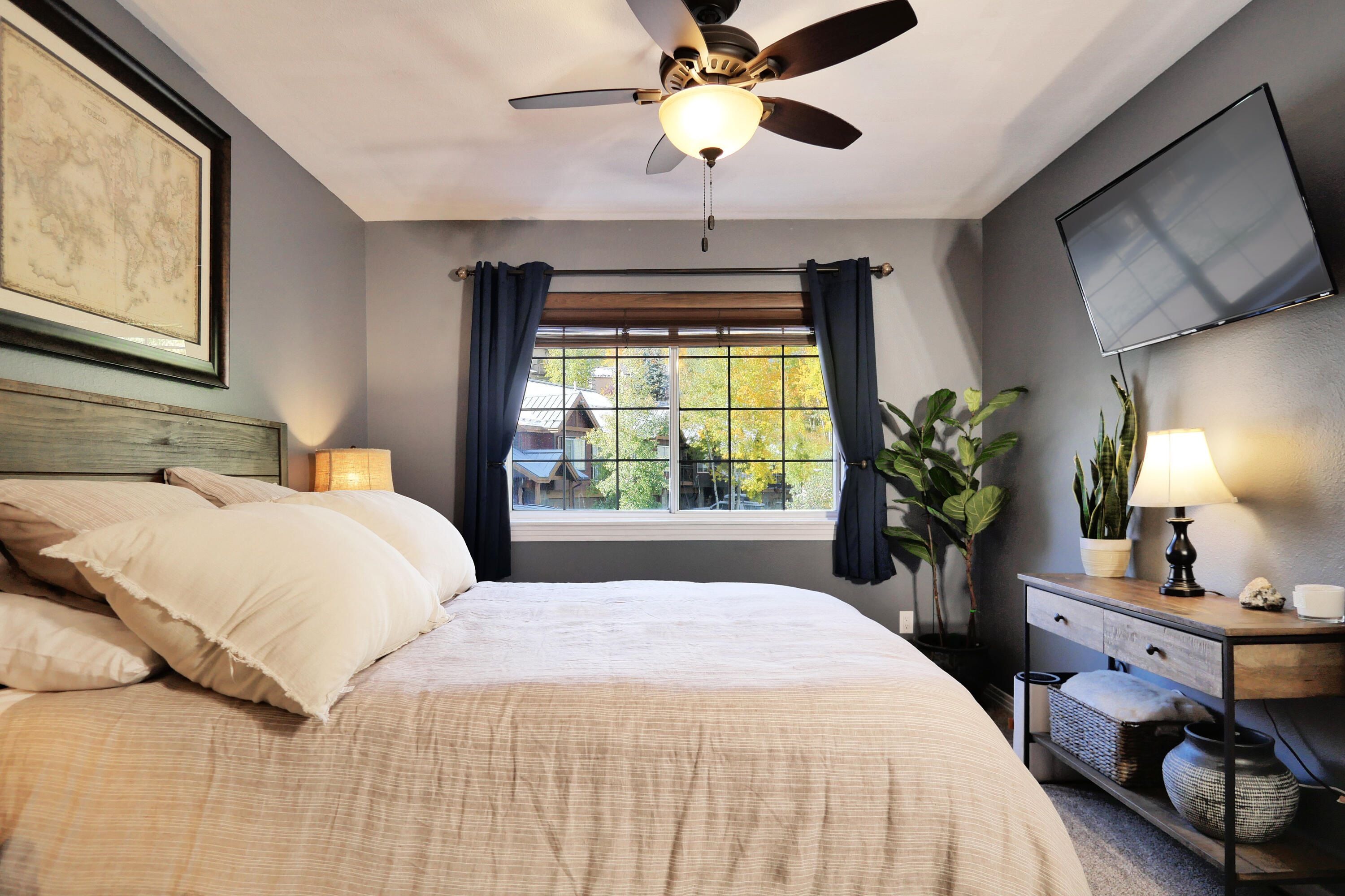 302 Adams Ranch Road, Unit 6 Mountain Village, CO 81435 - Photo 28 of 45 a bedroom with a bed and a chandelier