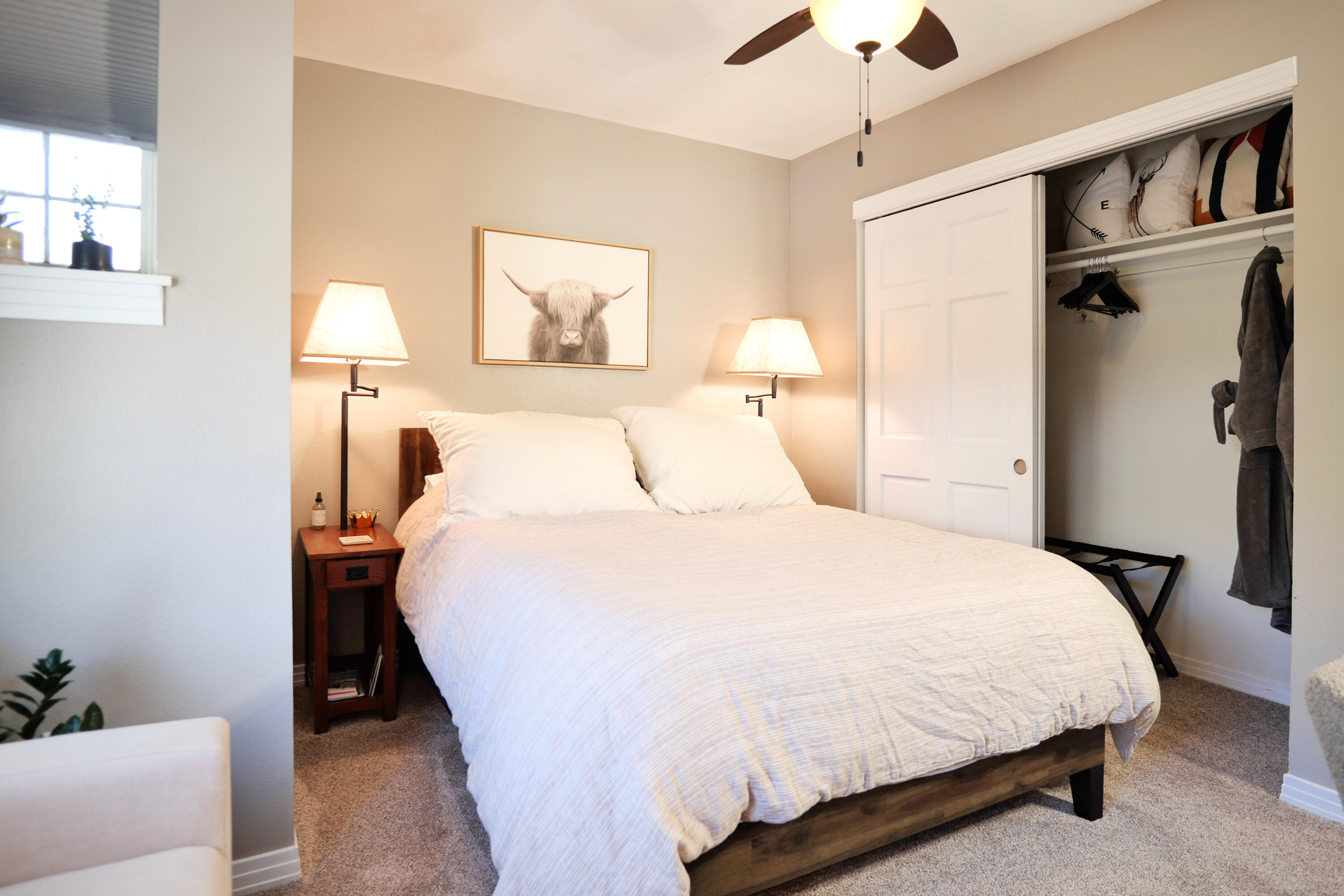 302 Adams Ranch Road, Unit 6 Mountain Village, CO 81435 - Photo 33 of 45 a bedroom with a large bed and a chandelier