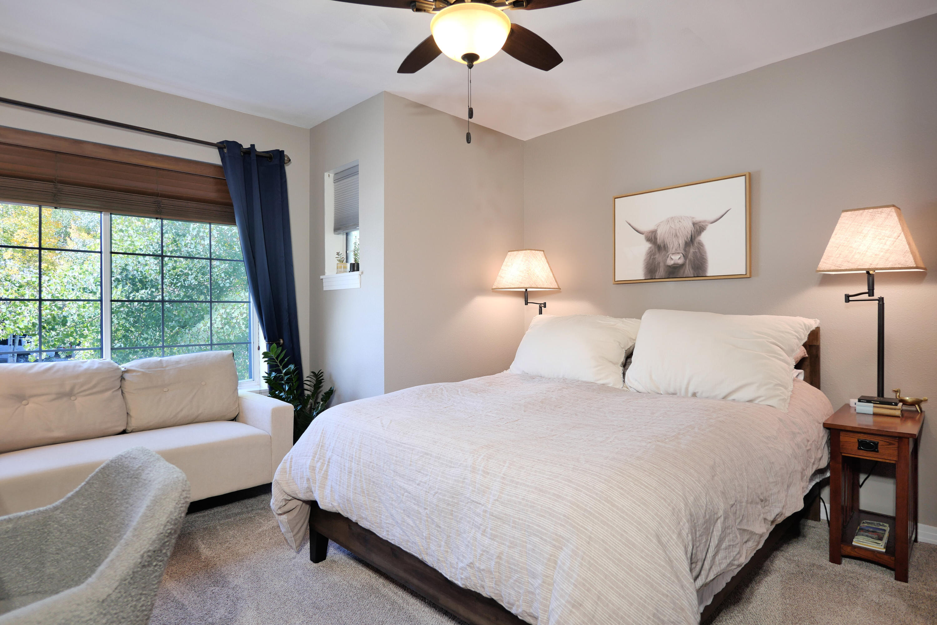 302 Adams Ranch Road, Unit 6 Mountain Village, CO 81435 - Photo 34 of 45 a bedroom with a bed and a chandelier