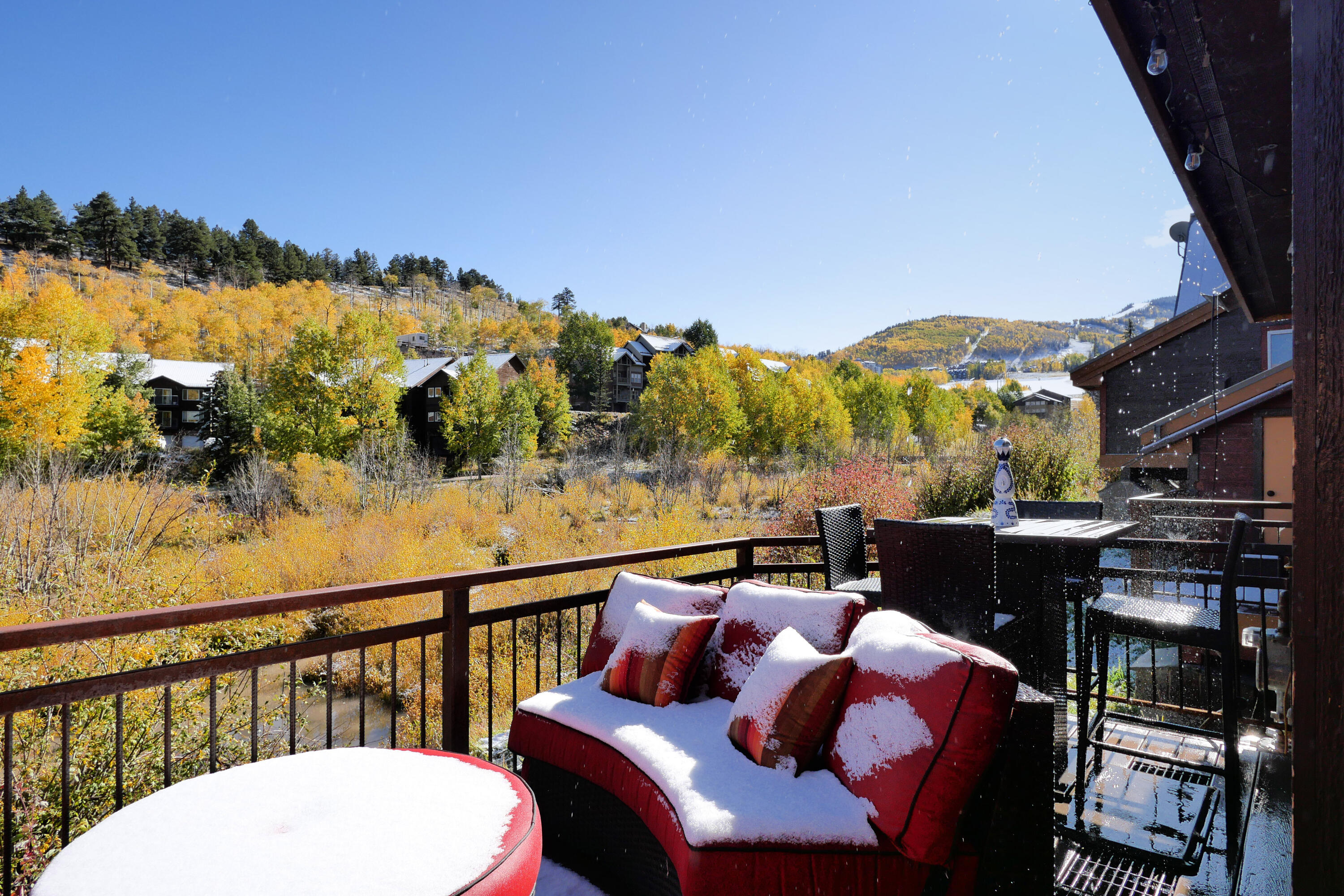302 Adams Ranch Road, Unit 6 Mountain Village, CO 81435 - Photo 36 of 45 a view of a balcony with chair and wooden floor