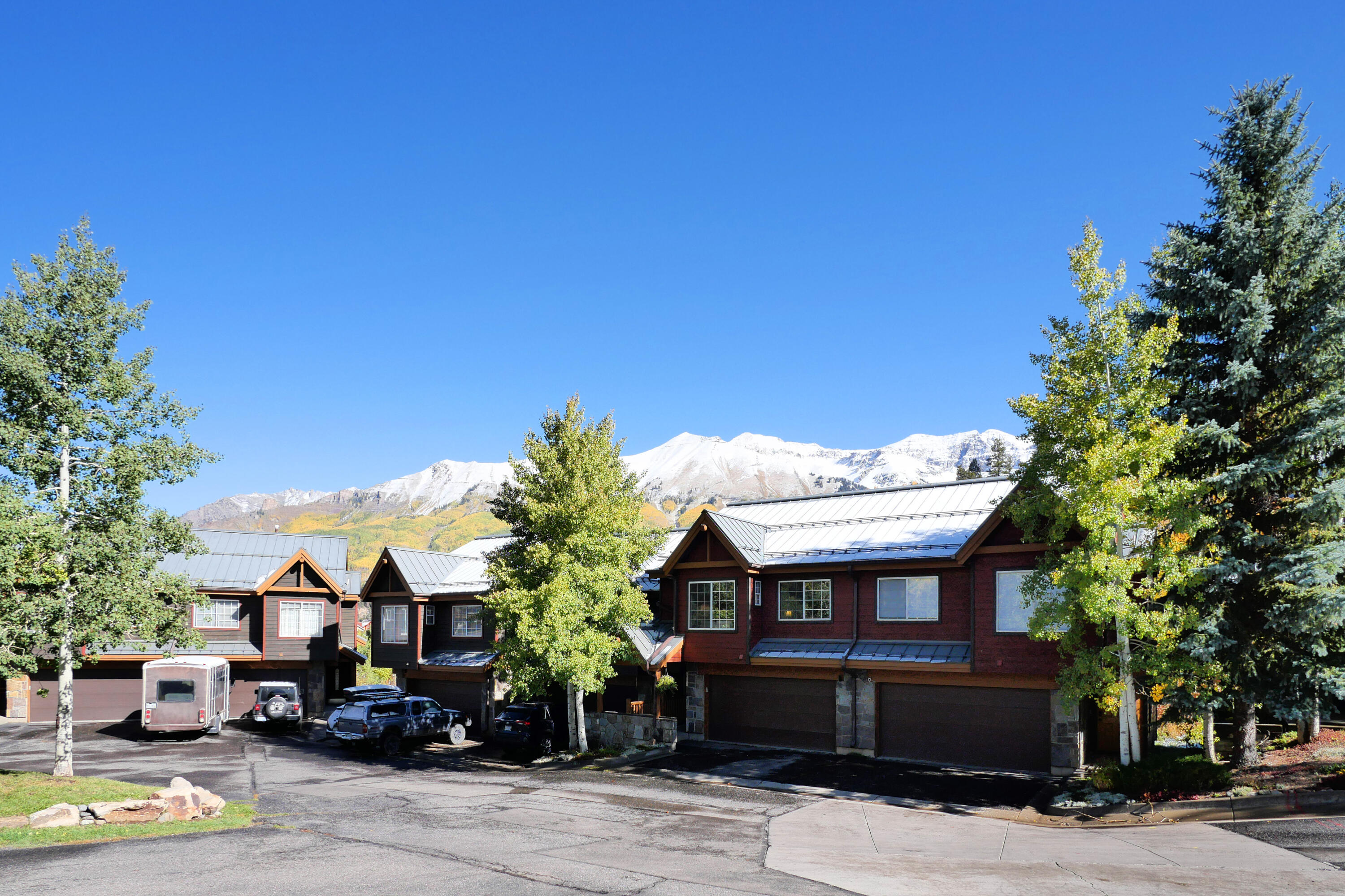 302 Adams Ranch Road, Unit 6 Mountain Village, CO 81435 - Photo 41 of 45 a front view of a house with a garden