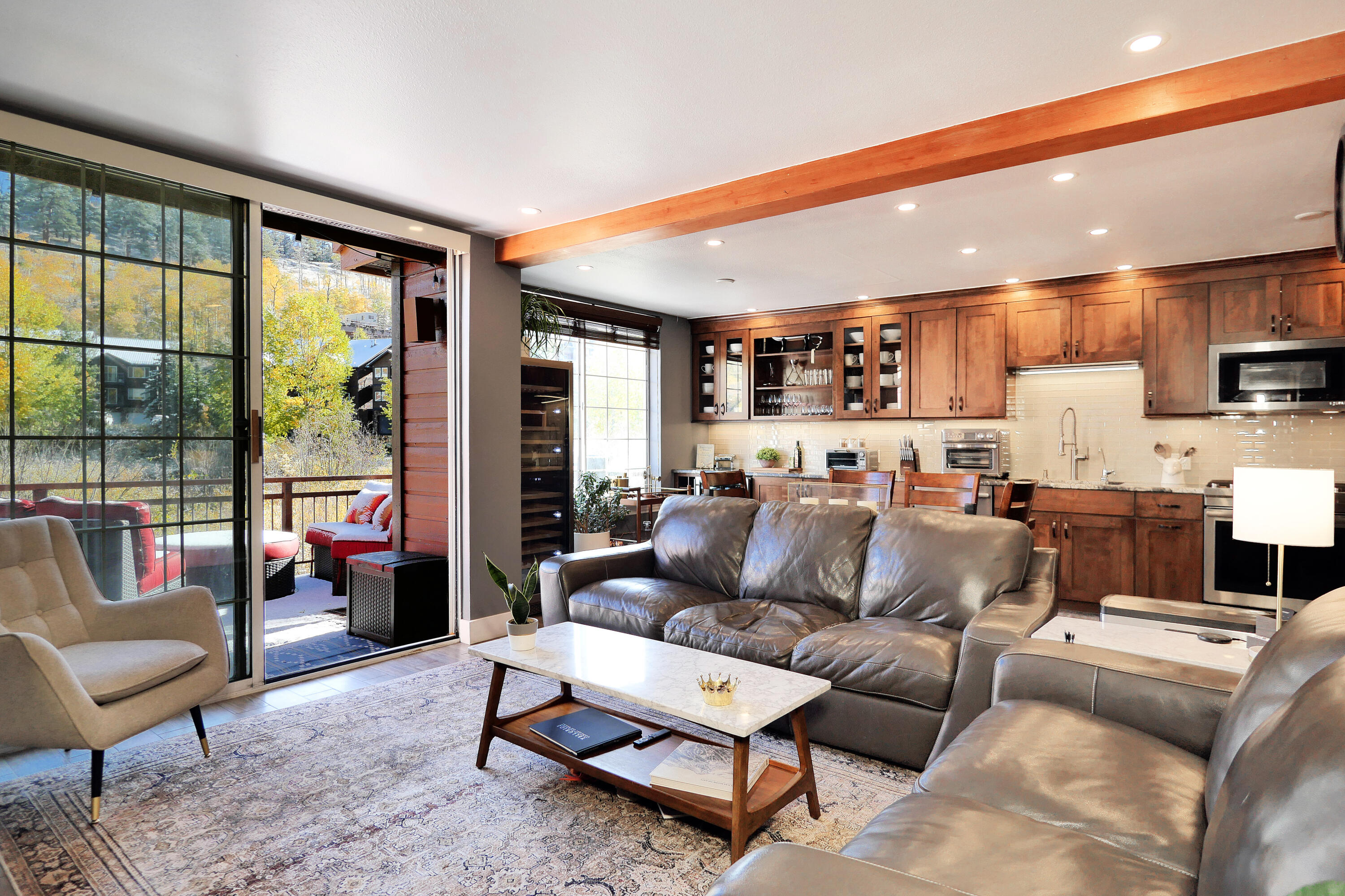 302 Adams Ranch Road, Unit 6 Mountain Village, CO 81435 - Photo 7 of 45 a living room with furniture and a large window