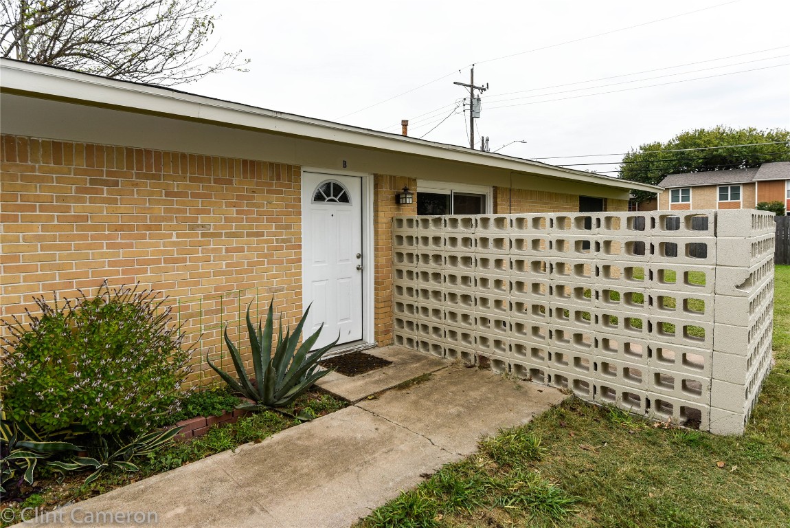 8005 Pinedale Cove, Unit B Austin, TX 78757 - Photo 1 of 22 a front view of a house with a garden