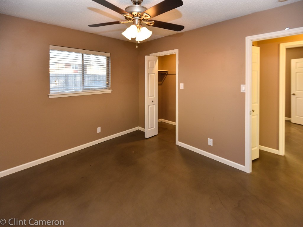 8005 Pinedale Cove, Unit B Austin, TX 78757 - Photo 12 of 22 an empty room with windows and fan