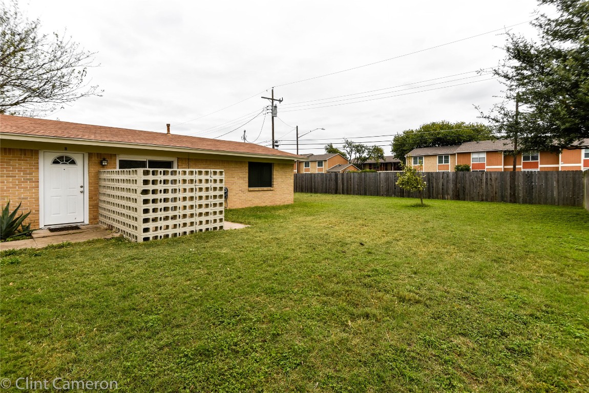 8005 Pinedale Cove, Unit B Austin, TX 78757 - Photo 15 of 22 a backyard of a house with lots of green space