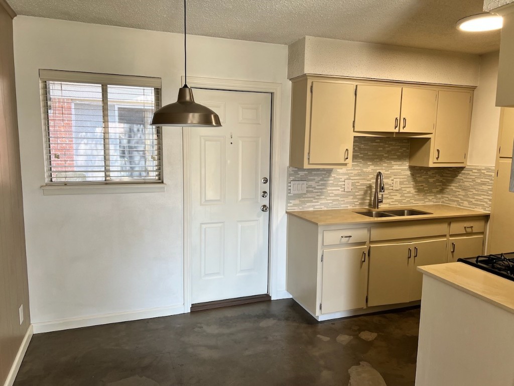 8005 Pinedale Cove, Unit B Austin, TX 78757 - Photo 2 of 22 a kitchen with stainless steel appliances granite countertop a sink a stove and a refrigerator