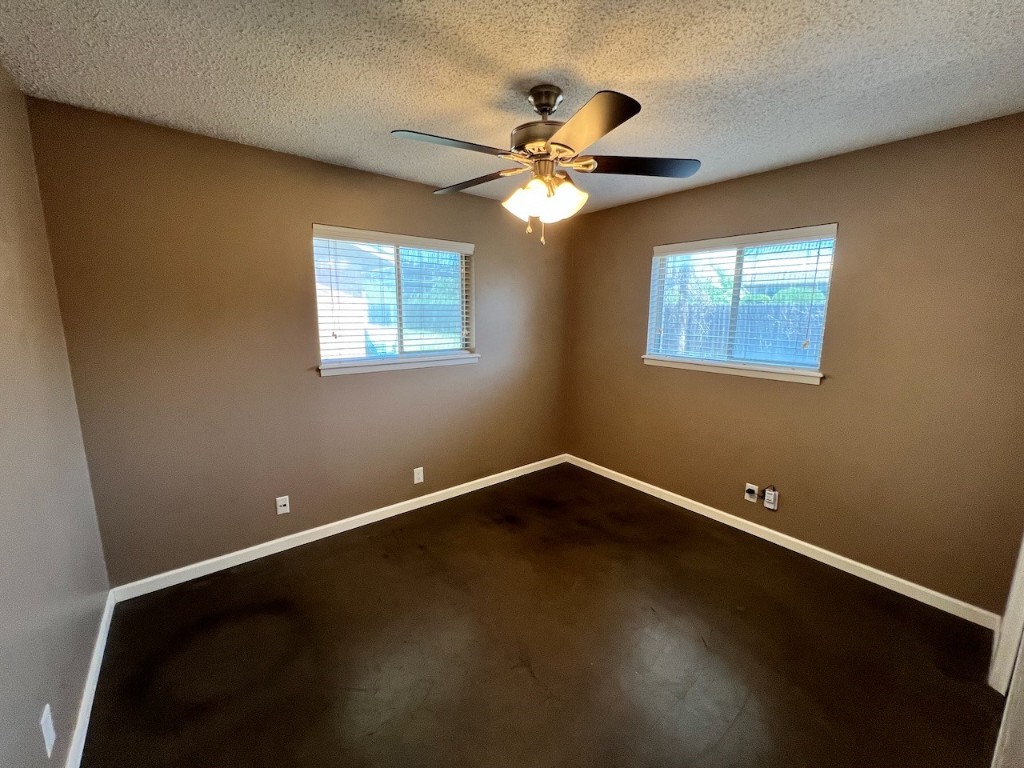 8005 Pinedale Cove, Unit B Austin, TX 78757 - Photo 10 of 22 a view of an empty room with a window and wooden floor