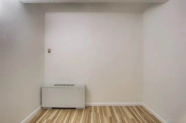 a view of a room with wooden floor and window
