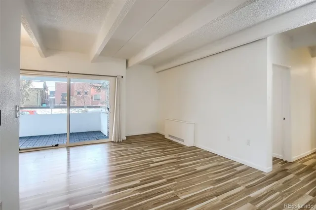 a view of room with window and wooden floor