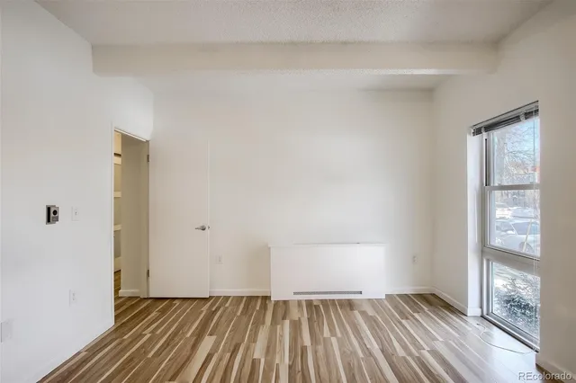 a view of a room with wooden floor and staircase