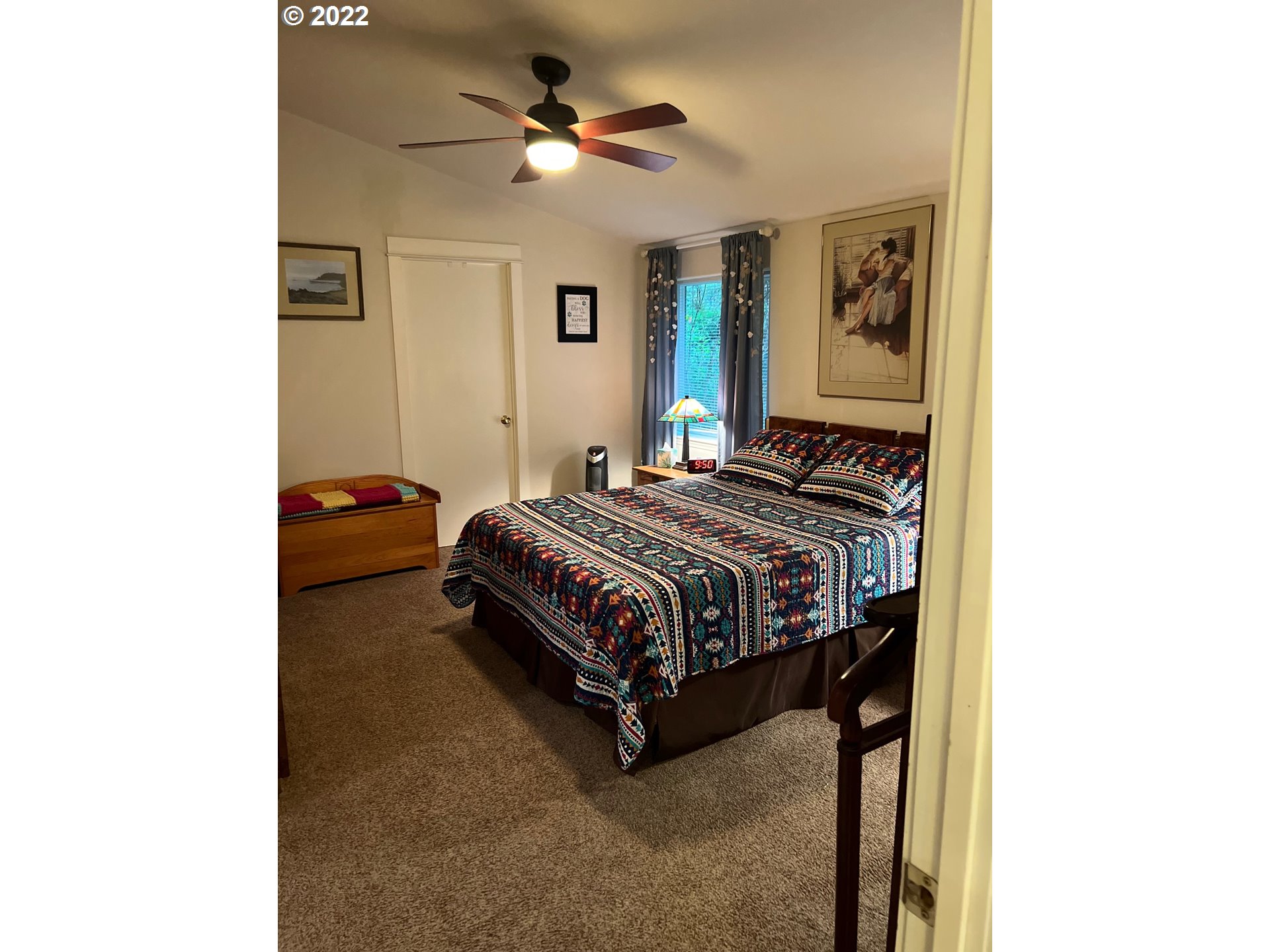 931 30th Way Florence, OR 97439 - Photo 15 of 23 a bedroom with a bed and a chandelier