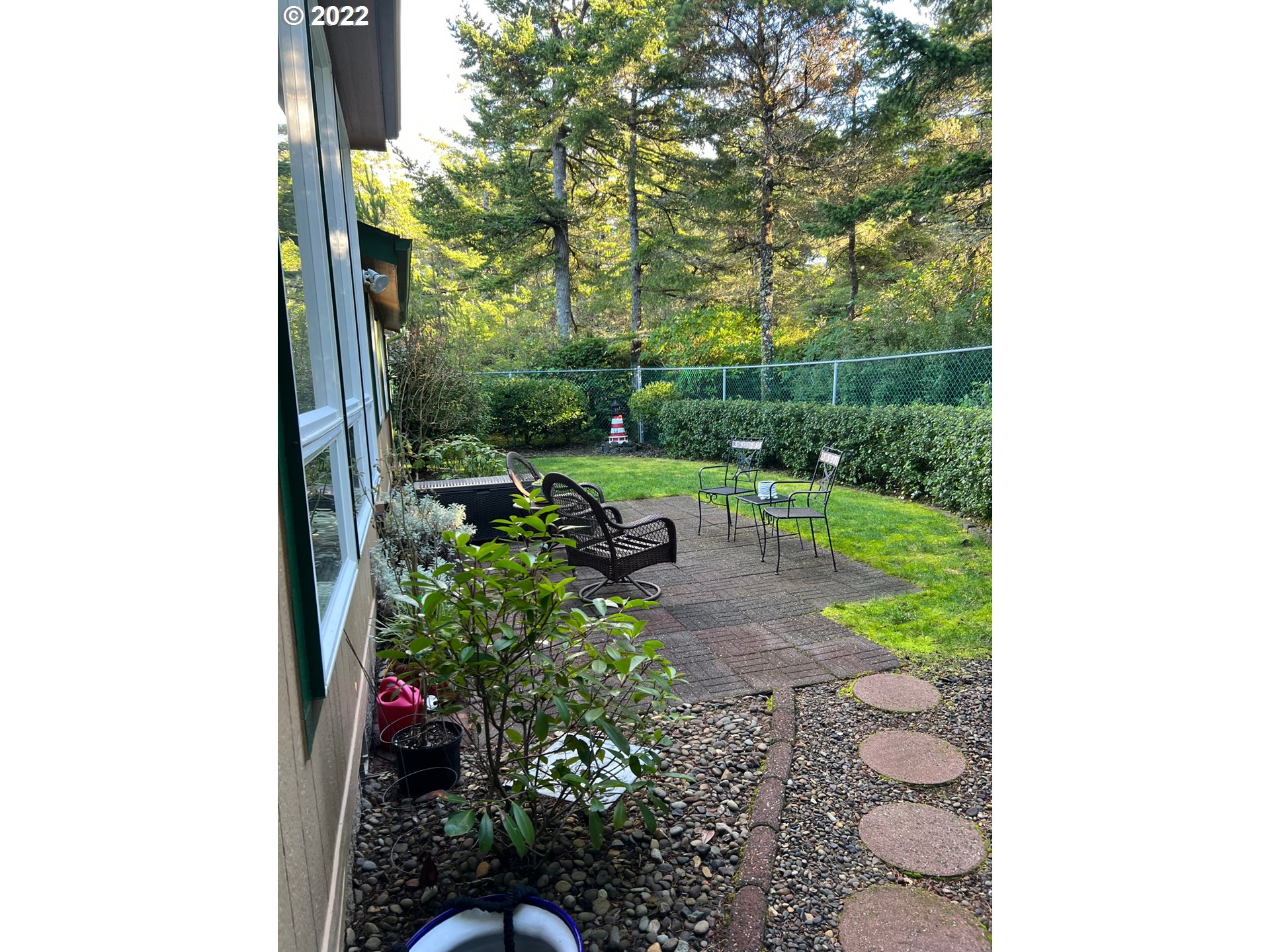 931 30th Way Florence, OR 97439 - Photo 2 of 23 a backyard of a house with lots of green space