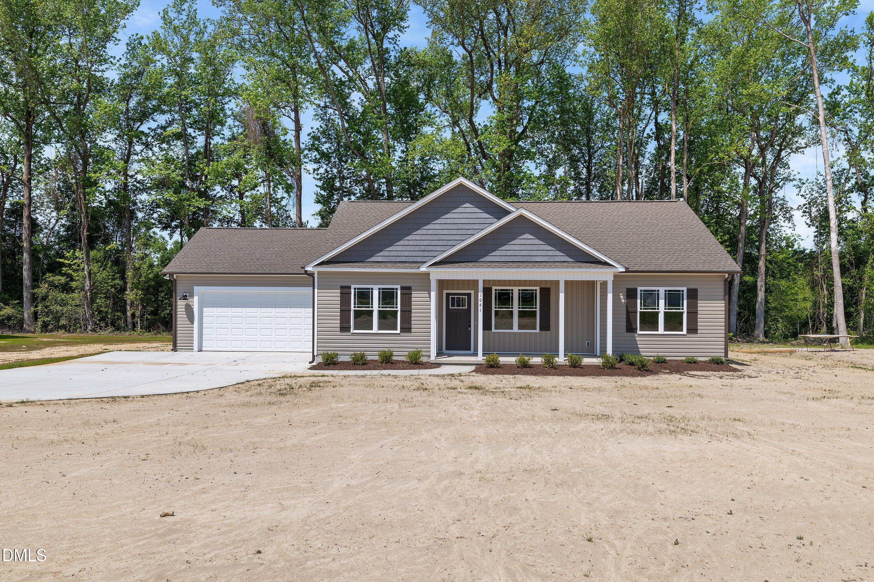 1061 Nor-Am Road Pikeville, NC 27863 - Photo 1 of 39 a front view of a house with a garden