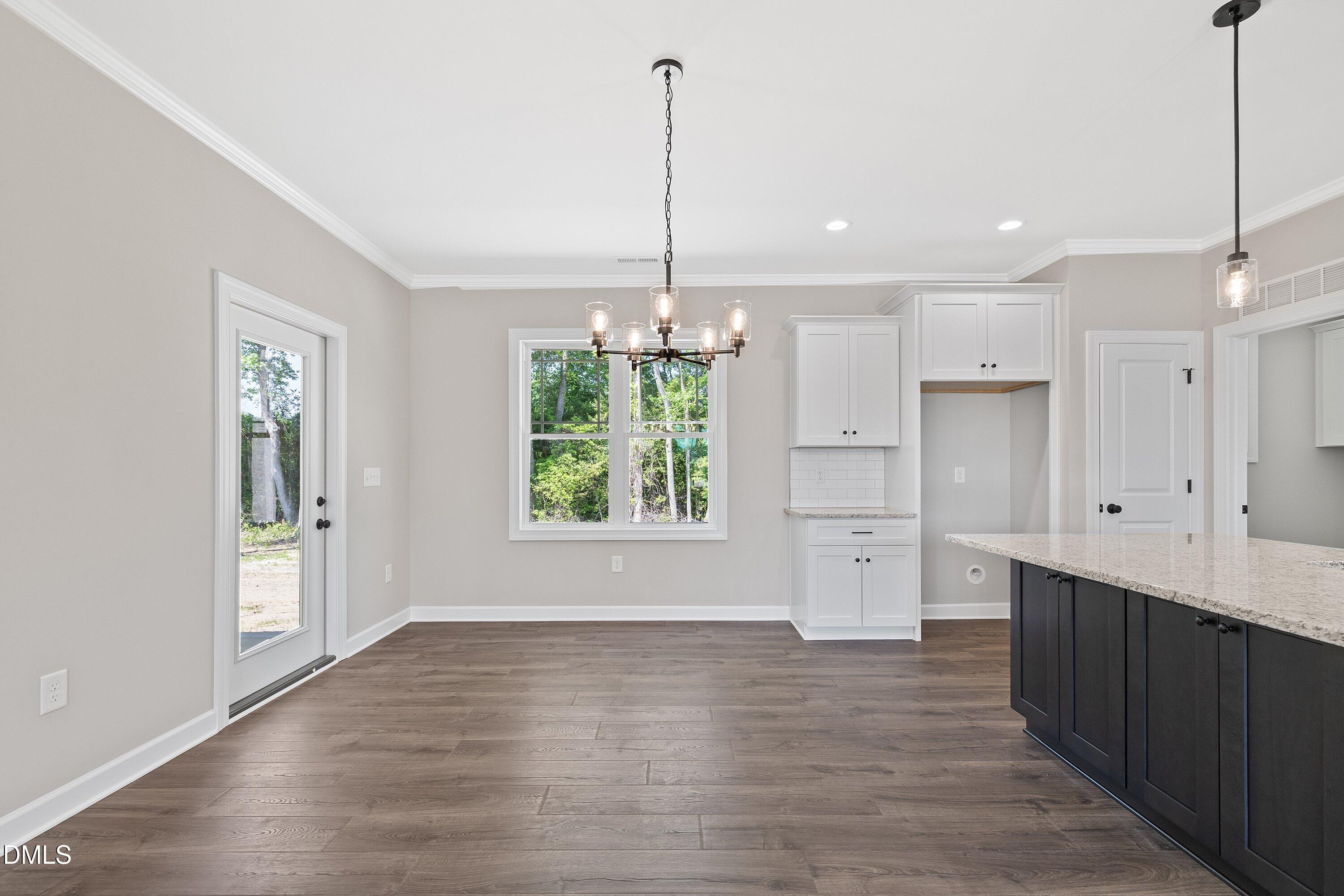 1061 Nor-Am Road Pikeville, NC 27863 - Photo 12 of 39 a view of a kitchen with white cabinets and wooden floor