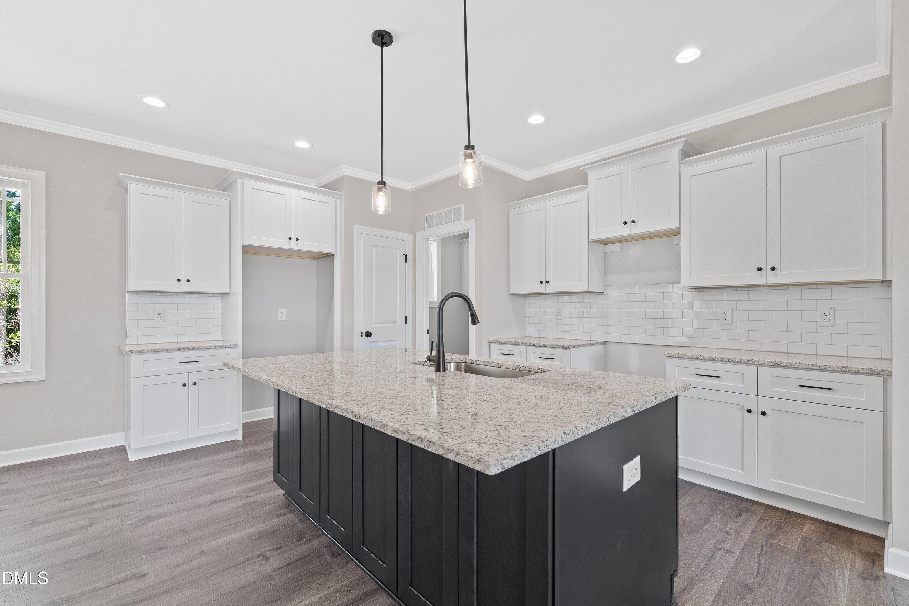 1061 Nor-Am Road Pikeville, NC 27863 - Photo 13 of 39 a kitchen with a sink window and cabinets