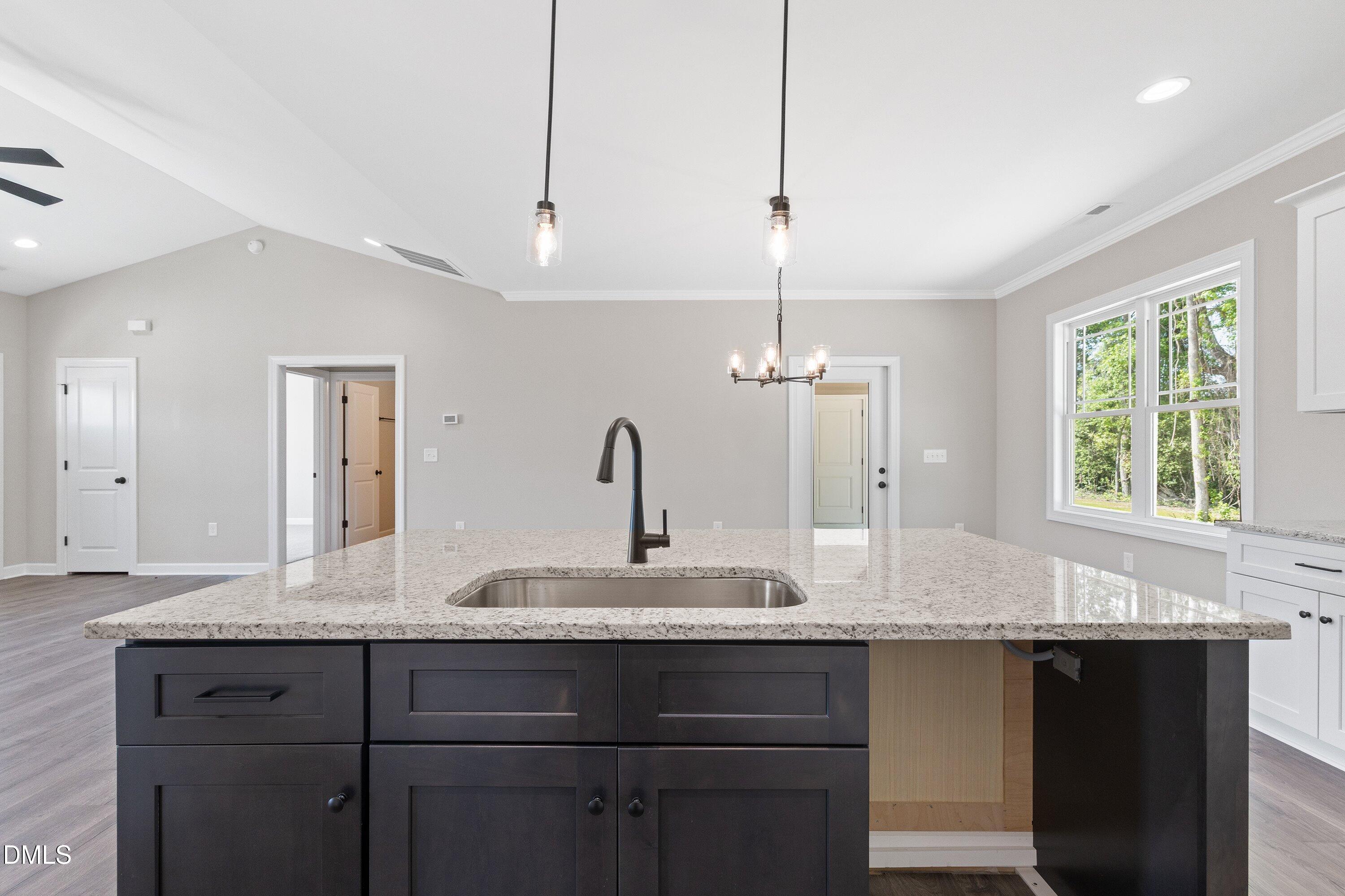 1061 Nor-Am Road Pikeville, NC 27863 - Photo 17 of 39 a bathroom with granite countertop a sink and a window