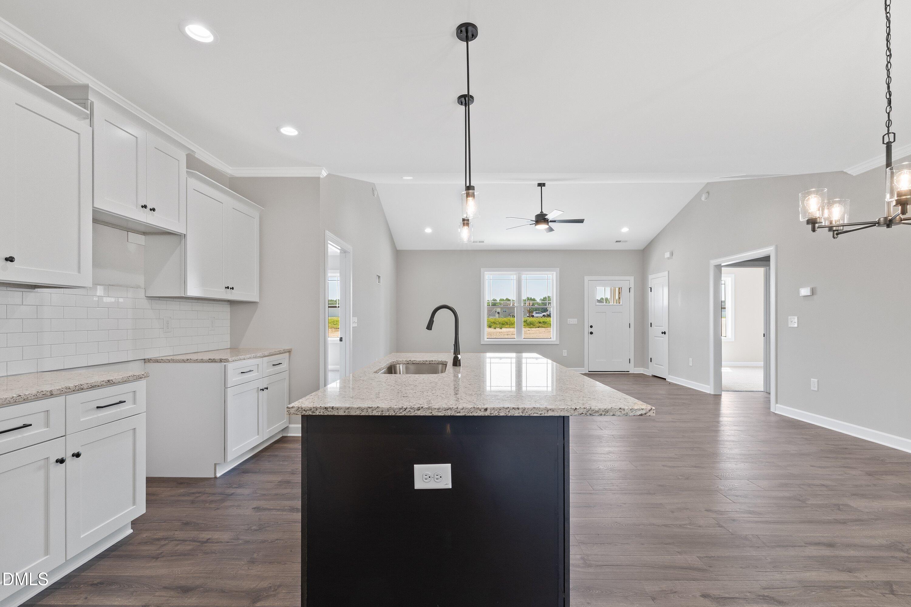 1061 Nor-Am Road Pikeville, NC 27863 - Photo 19 of 39 a kitchen with kitchen island a sink stainless steel appliances and cabinets