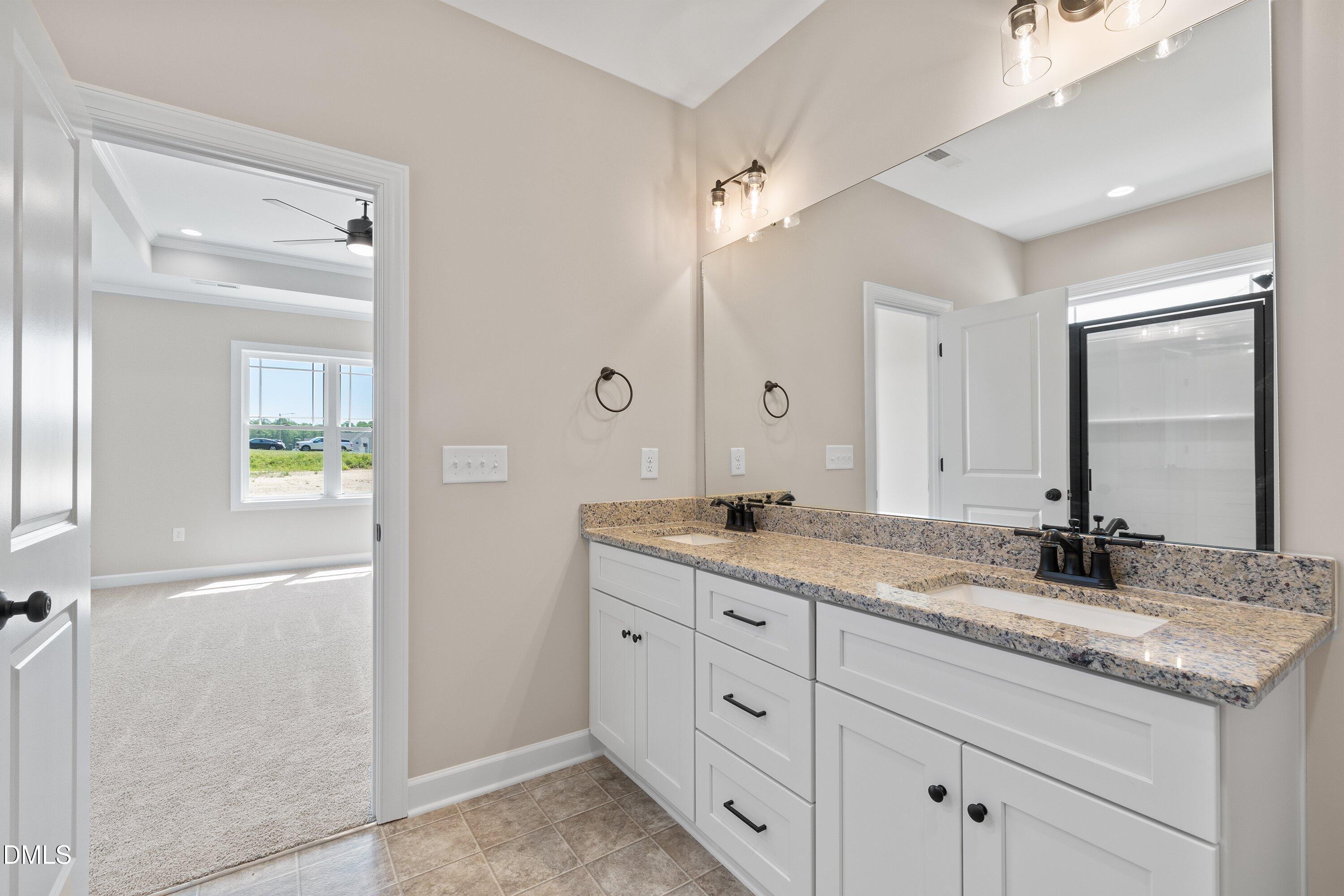 1061 Nor-Am Road Pikeville, NC 27863 - Photo 26 of 39 a bathroom with a granite countertop sink double and mirror