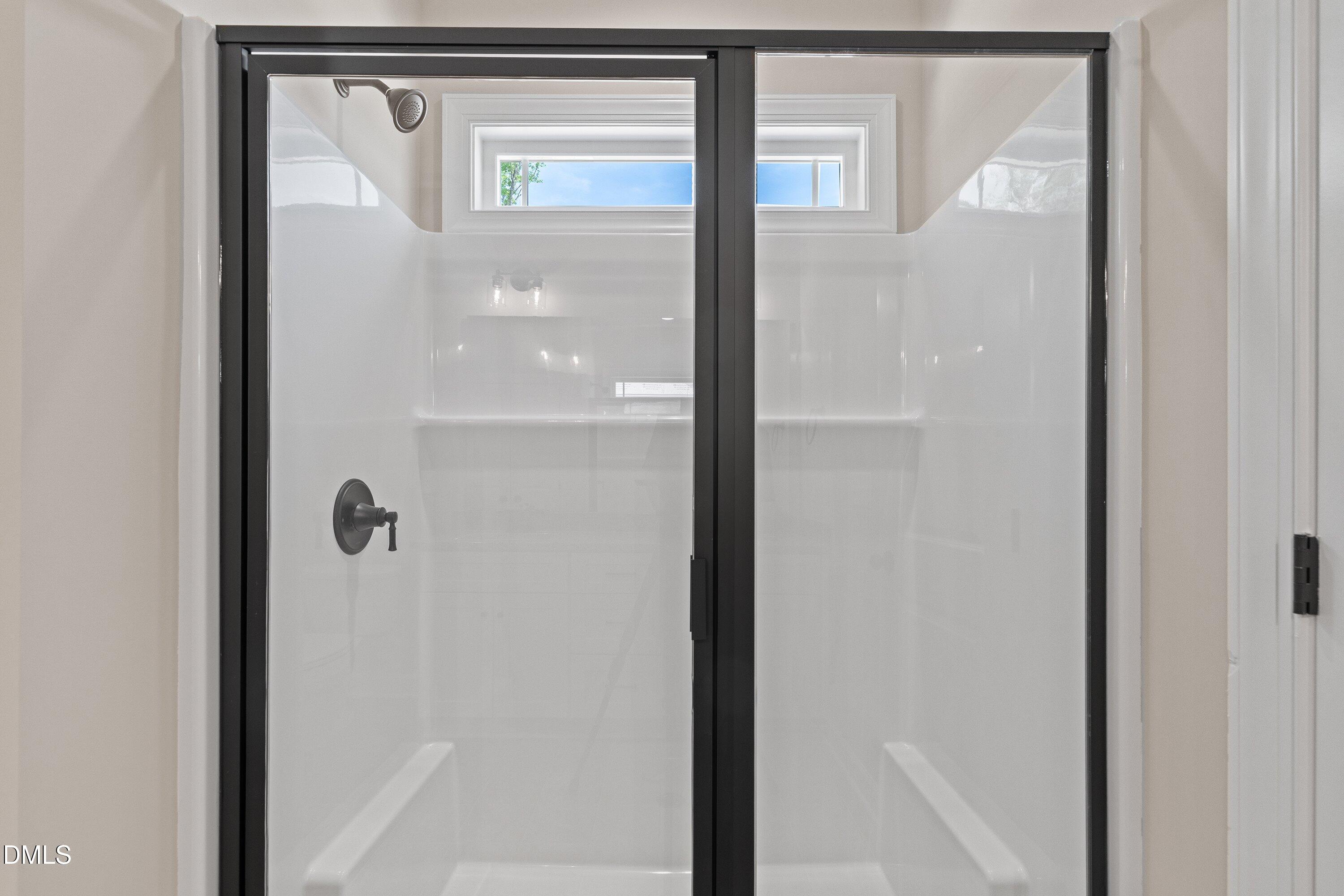 1061 Nor-Am Road Pikeville, NC 27863 - Photo 27 of 39 a bathroom with a glass shower door