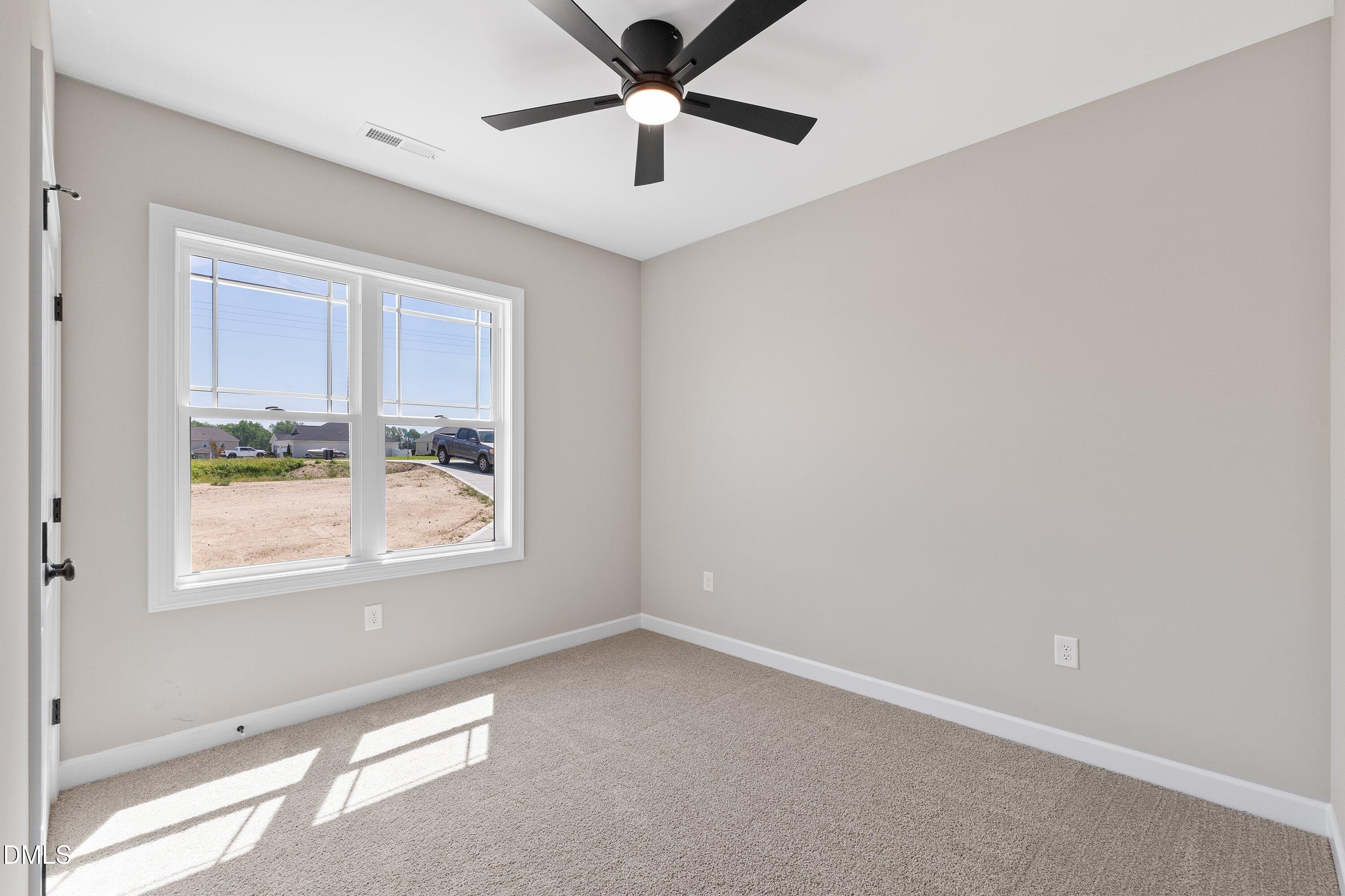 1061 Nor-Am Road Pikeville, NC 27863 - Photo 29 of 39 an empty room with windows and ceiling fan