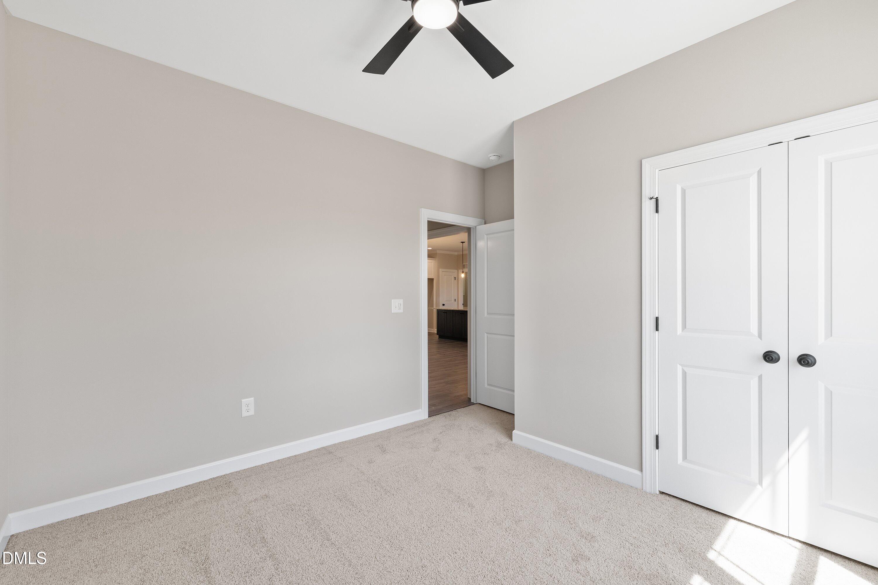 1061 Nor-Am Road Pikeville, NC 27863 - Photo 30 of 39 an empty room with a ceiling fan and carpet