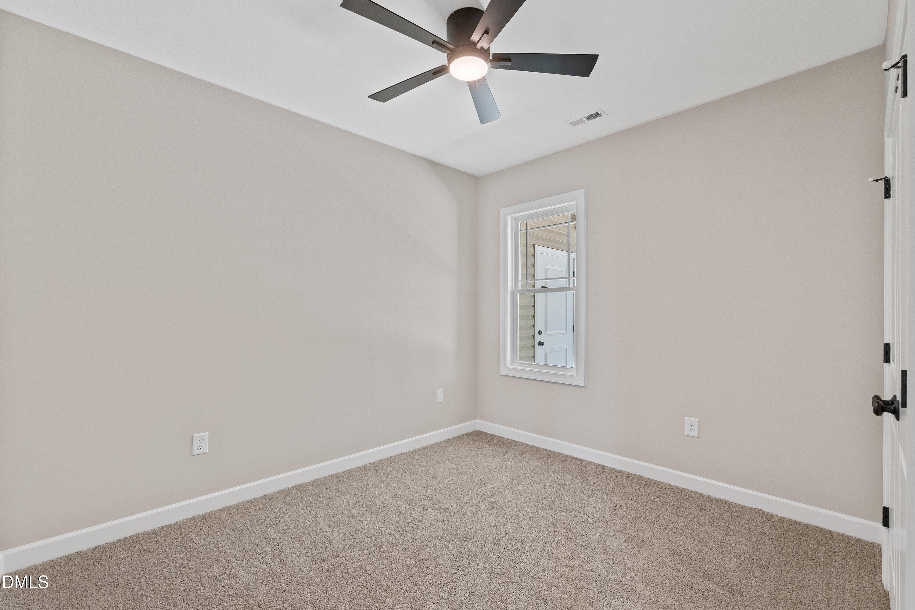 1061 Nor-Am Road Pikeville, NC 27863 - Photo 31 of 39 an empty room with a window and a fan