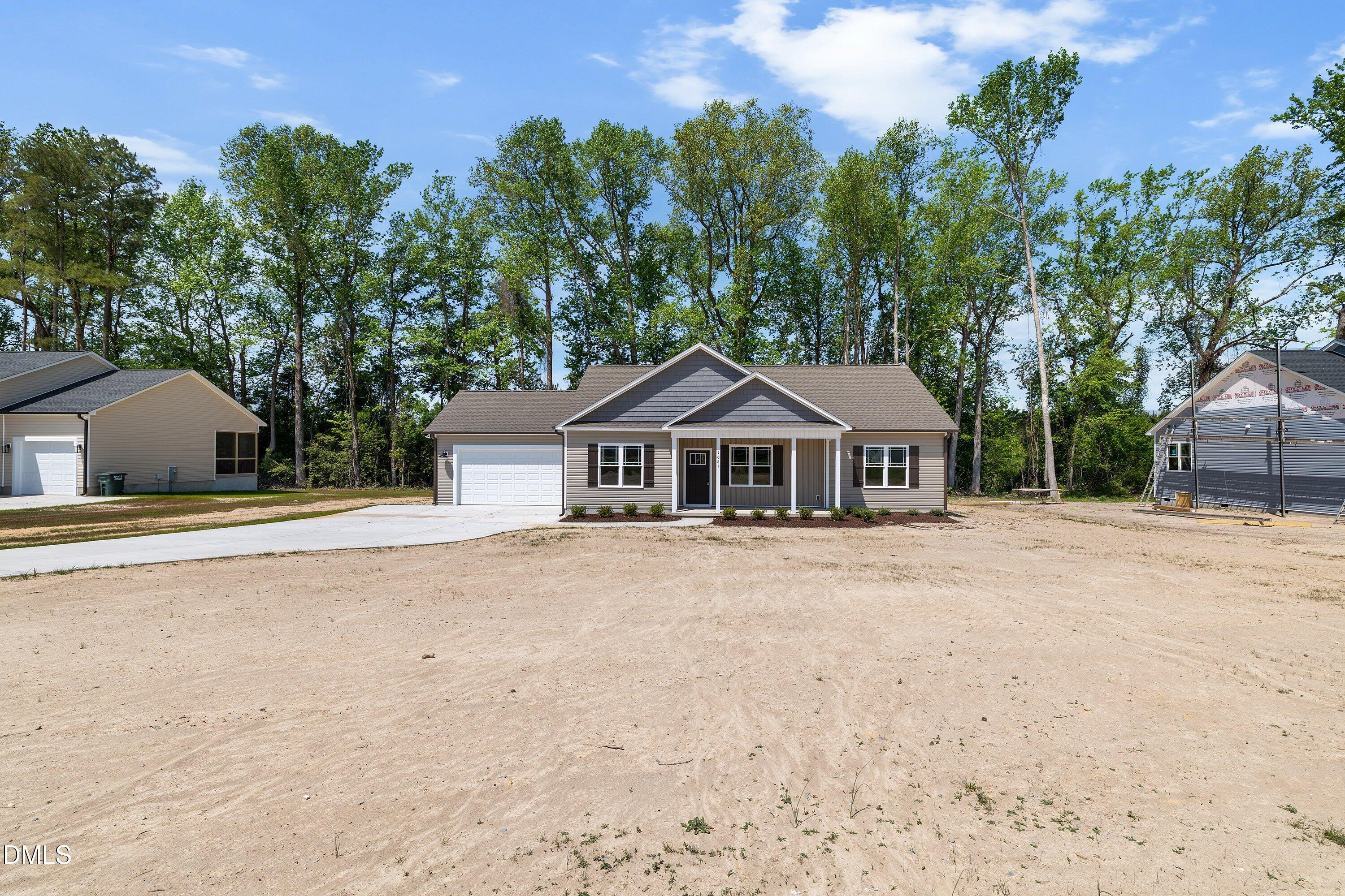 1061 Nor-Am Road Pikeville, NC 27863 - Photo 4 of 39 a front view of a house with yard and trees