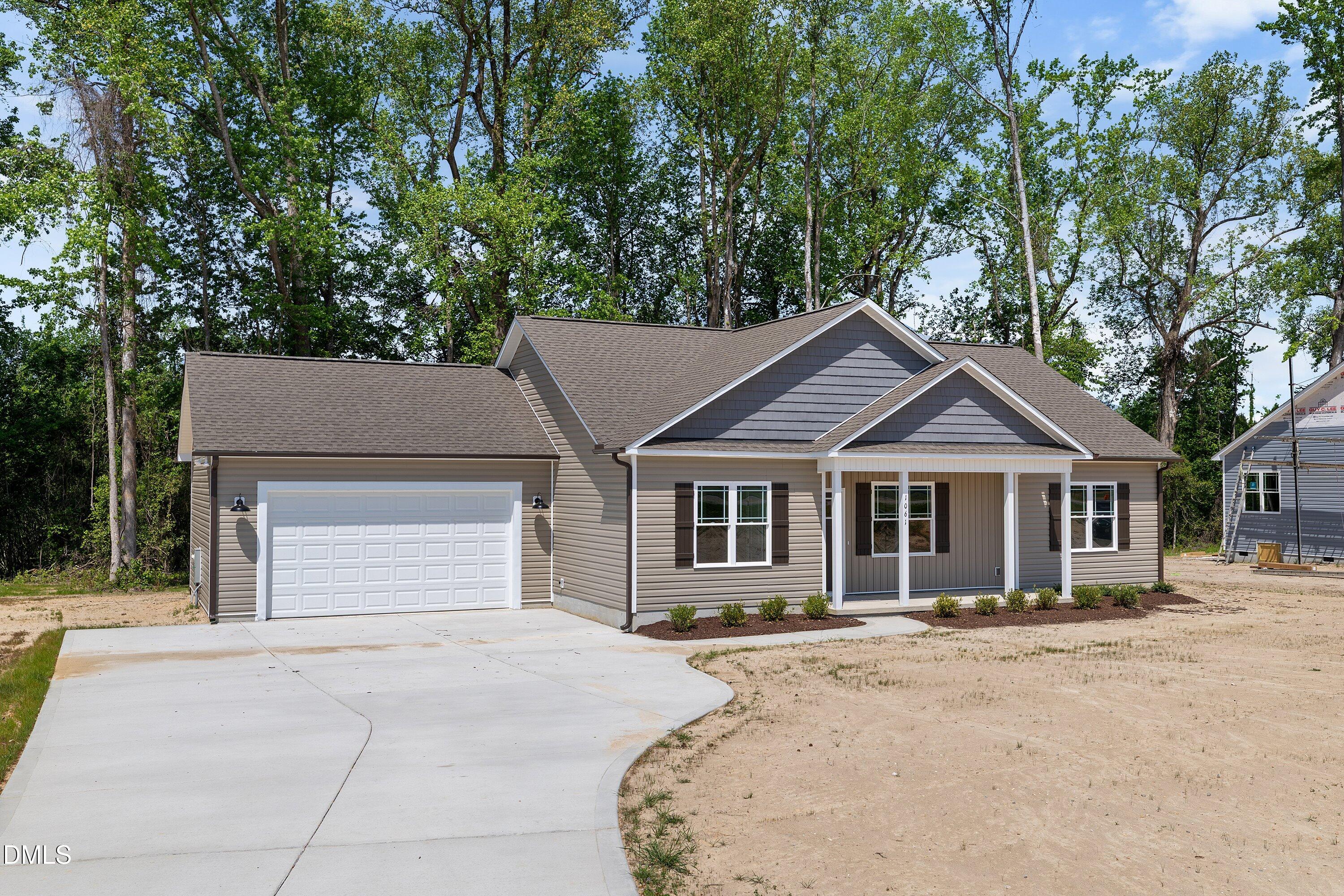 1061 Nor-Am Road Pikeville, NC 27863 - Photo 5 of 39 a front view of a house with a yard and garage