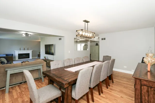 a view of a dining room with furniture wooden floor and chandelier