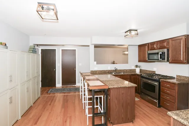 a kitchen with stainless steel appliances granite countertop a stove and a refrigerator