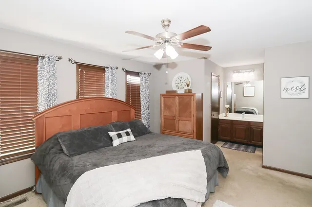 a bedroom with a large bed and a chandelier